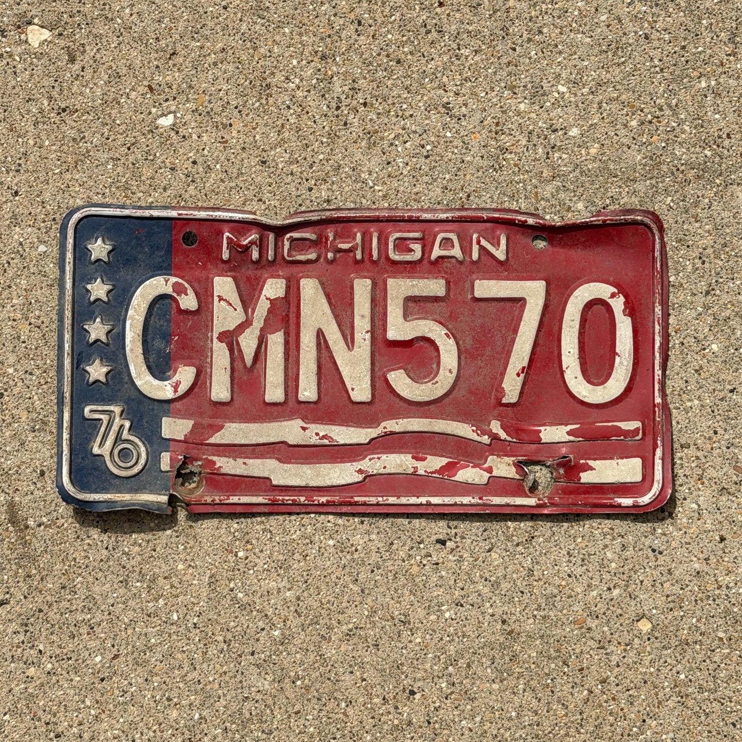 Photo of a 1976 Michigan License Plate Auto Tag Garage Decor Vintage Bicentennial CMN 570 with original patina