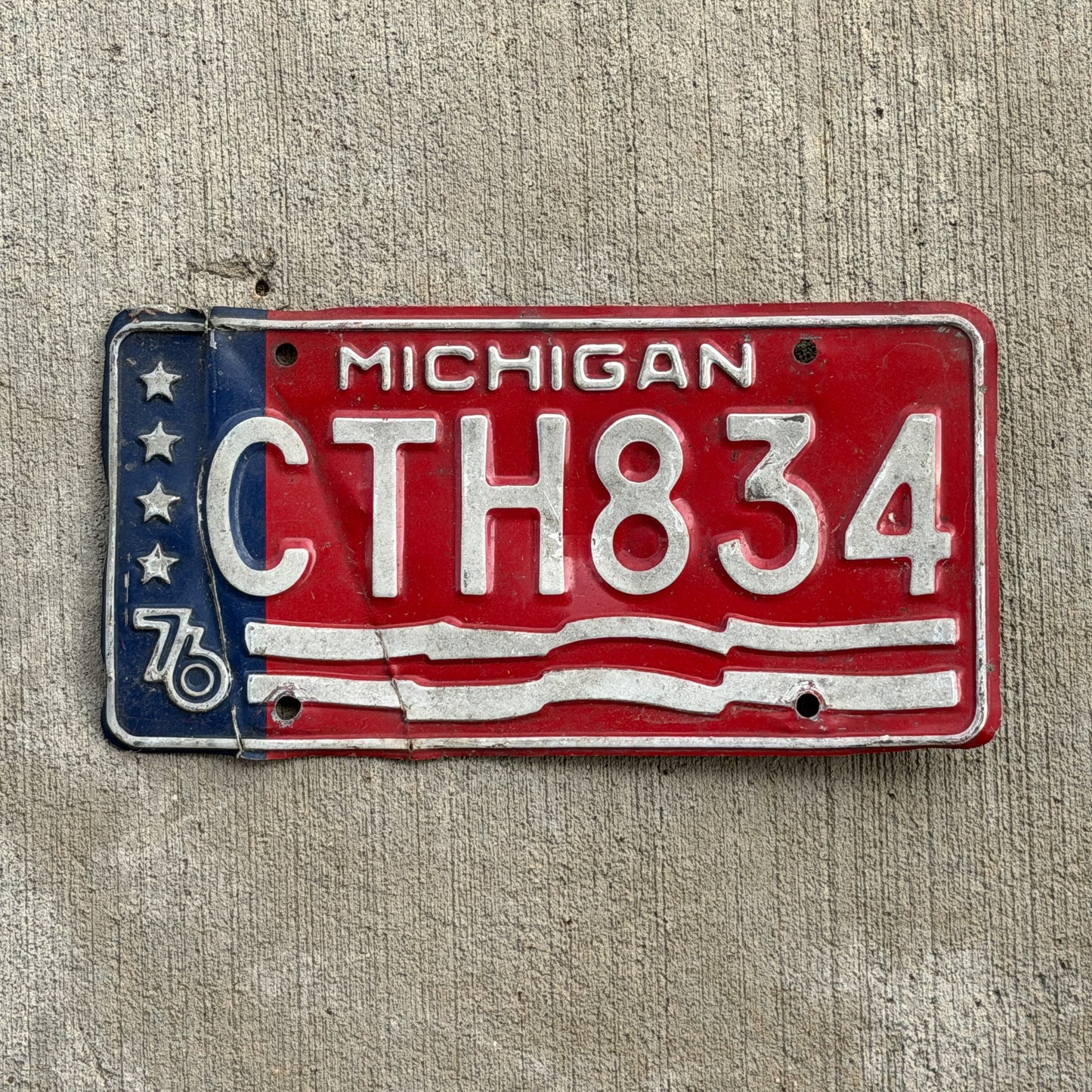 Photo of a 1976 Michigan License Plate Auto Tag Garage Decor Vintage Bicentennial CTH 834 with original patina