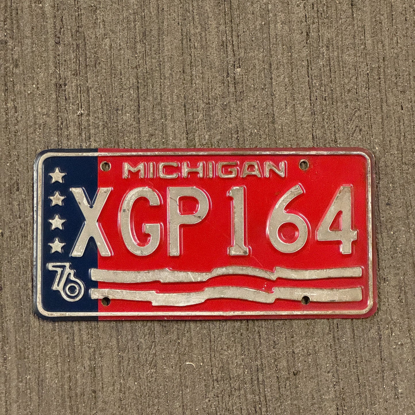Photo of a 1976 Michigan License Plate Auto Tag Garage Decor Vintage Bicentennial XGP 164