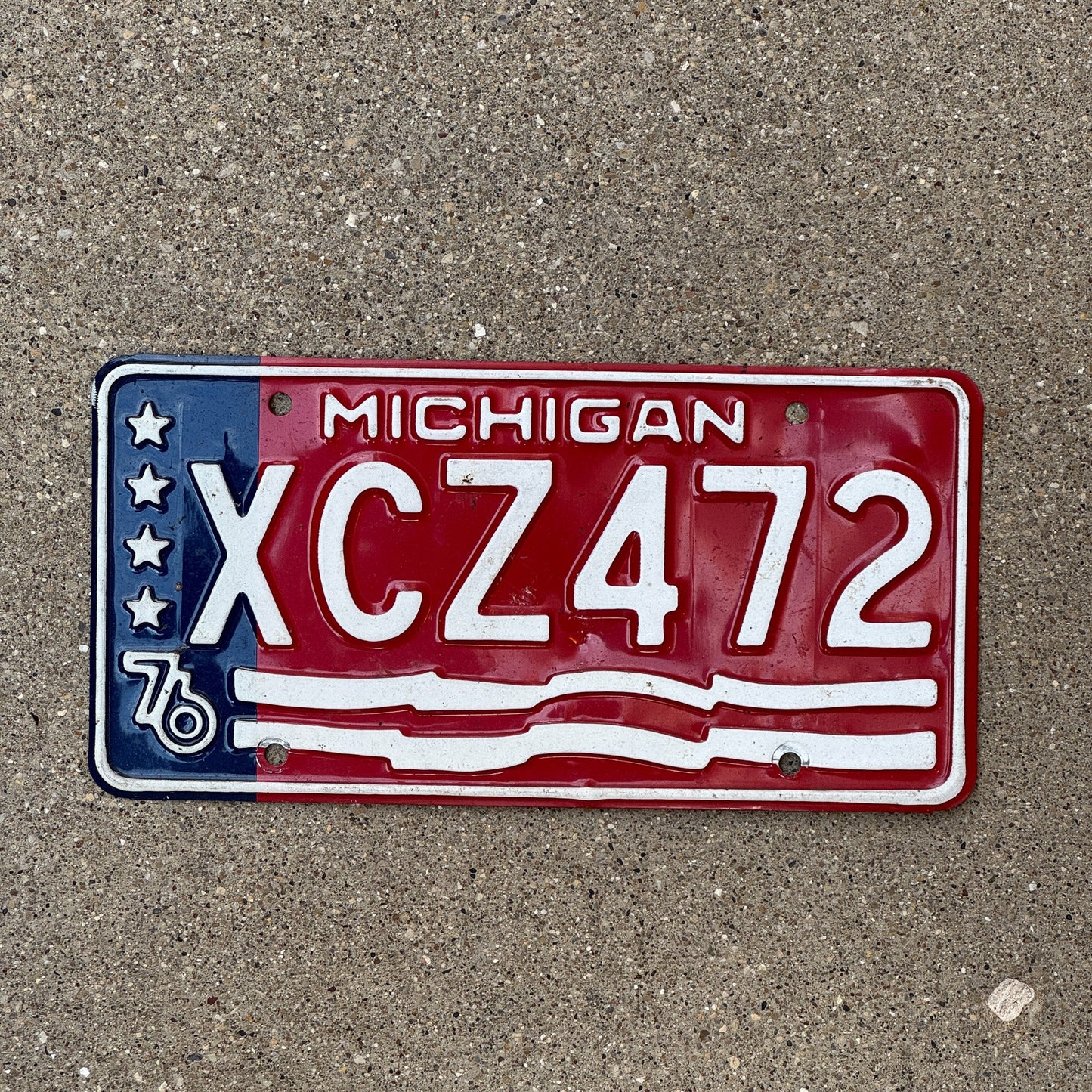 Photo of a 1976 Michigan License Plate Auto Tag Garage Decor Vintage XCZ 472