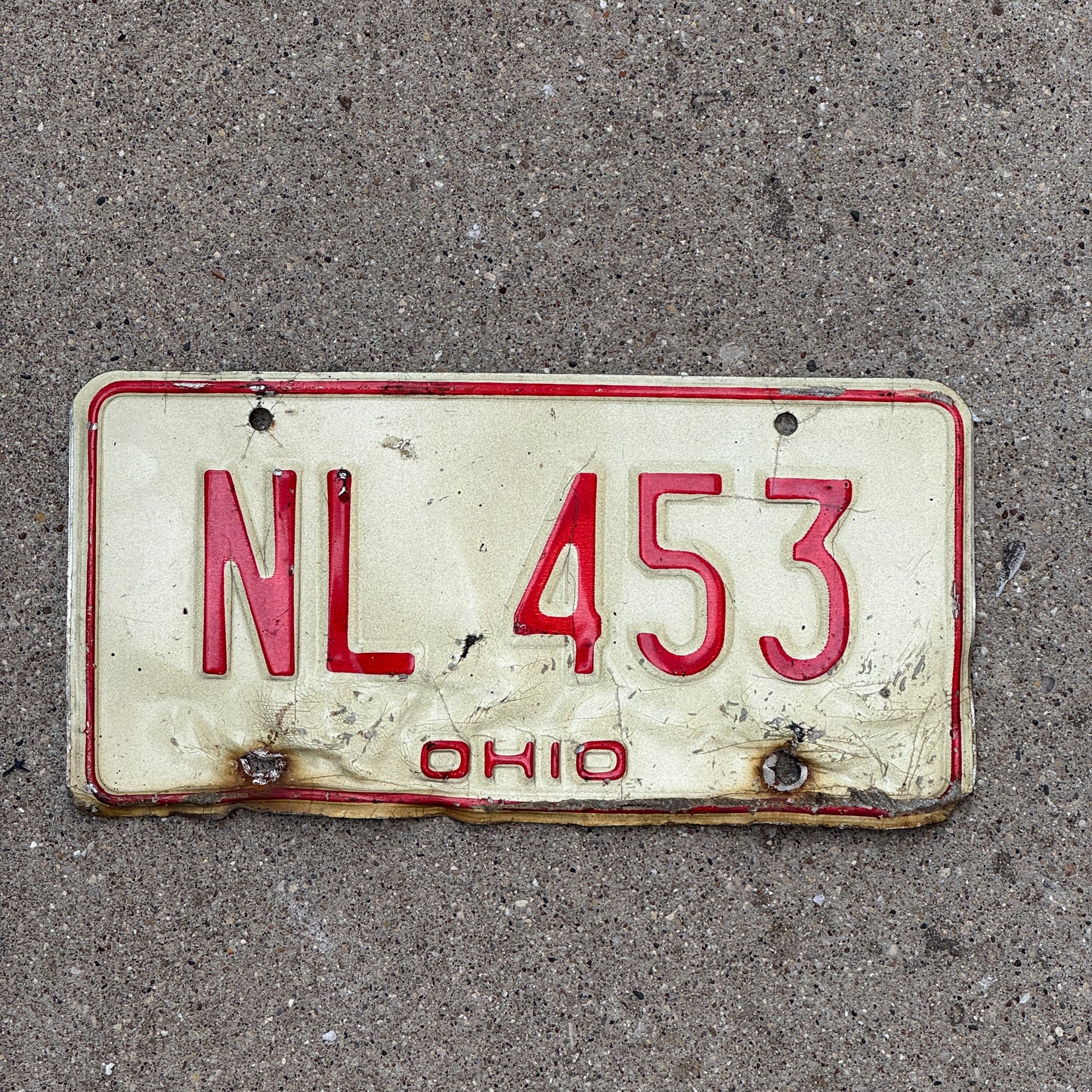 Photo of a 1976 Ohio License Plate Auto Tag 2 Vintage Garage NL 453 with original patina