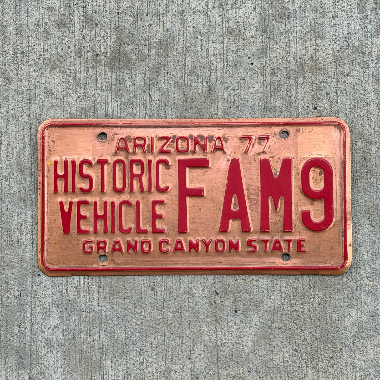 Photo of a 1977 Arizona Historic Vehicle License Plate Auto Tag Garage Decor Vintage Copper FAM 9 with original patina