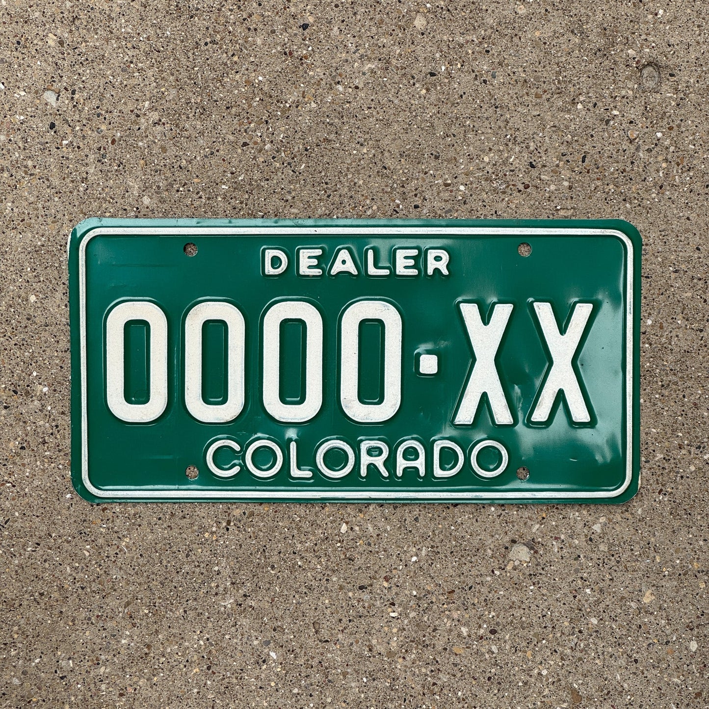 Photo of a 1977 Colorado Dealer Sample License Plate Auto Tag Garage Decor Vintage 0000 XX