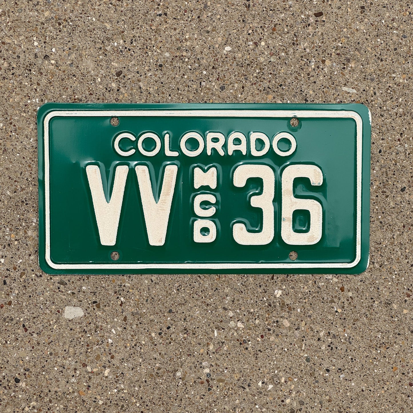 Photo of a 1977 Colorado Motorcycle Dealer License Plate Auto Tag Garage Decor Vintage VV 36