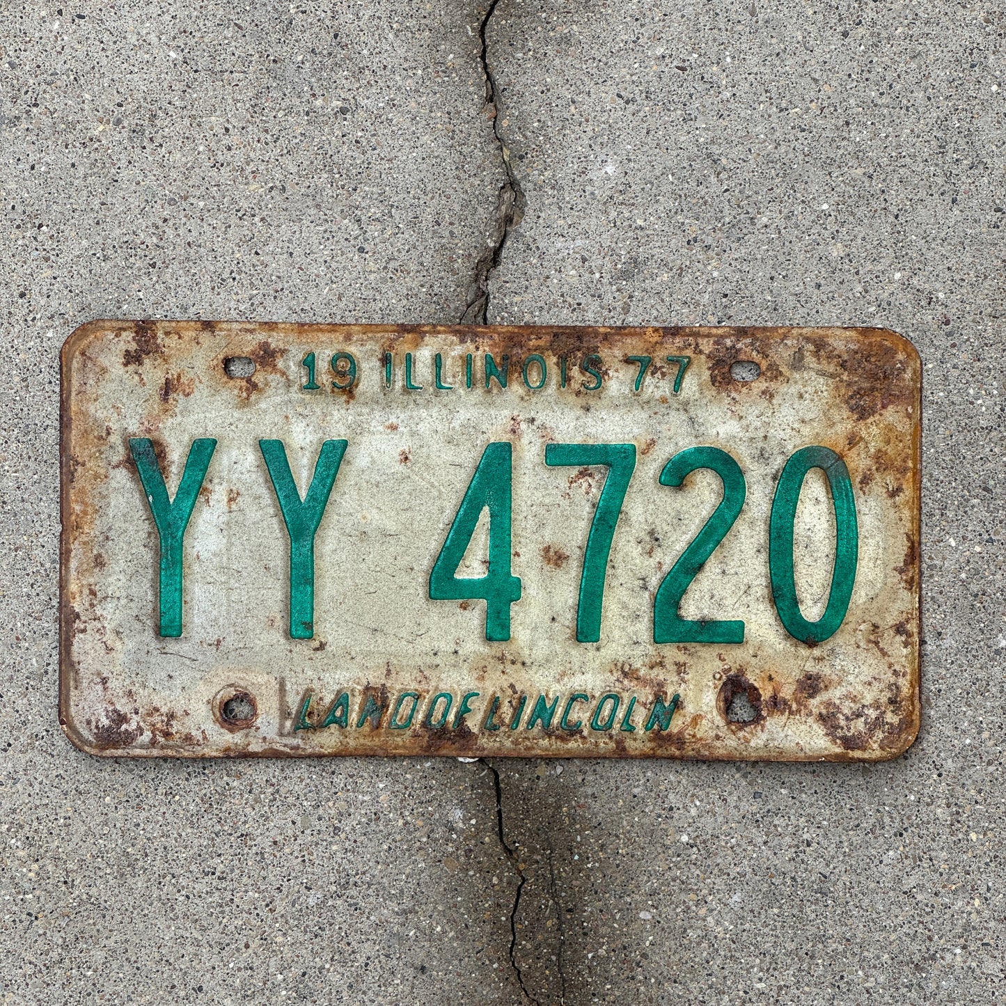Photo of a 1977 Illinois License Plate Auto Tag Garage Decor Vintage YY 4720 with original patina