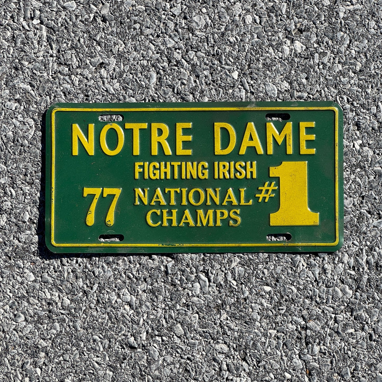 Photo of a 1977 Indiana Booster License Plate Auto Tag Garage Decor Vintage Notre Dame Fighting Irish National Champs