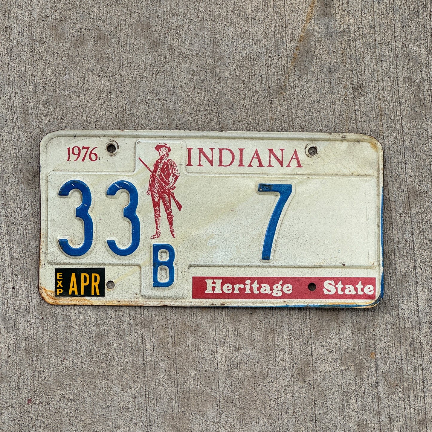 Photo of a 1977 Indiana License Plate Auto Tag Garage Decor Vintage Henry County Low Number 33 B 7 with original patina