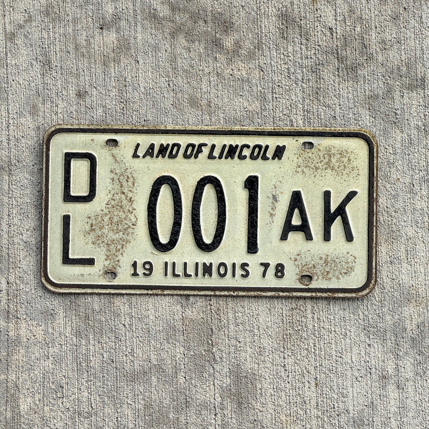 Photo of a 1978 Illinois Dealer License Plate Auto Tag Garage Decor Vintage Great Number 001 AK with original patina