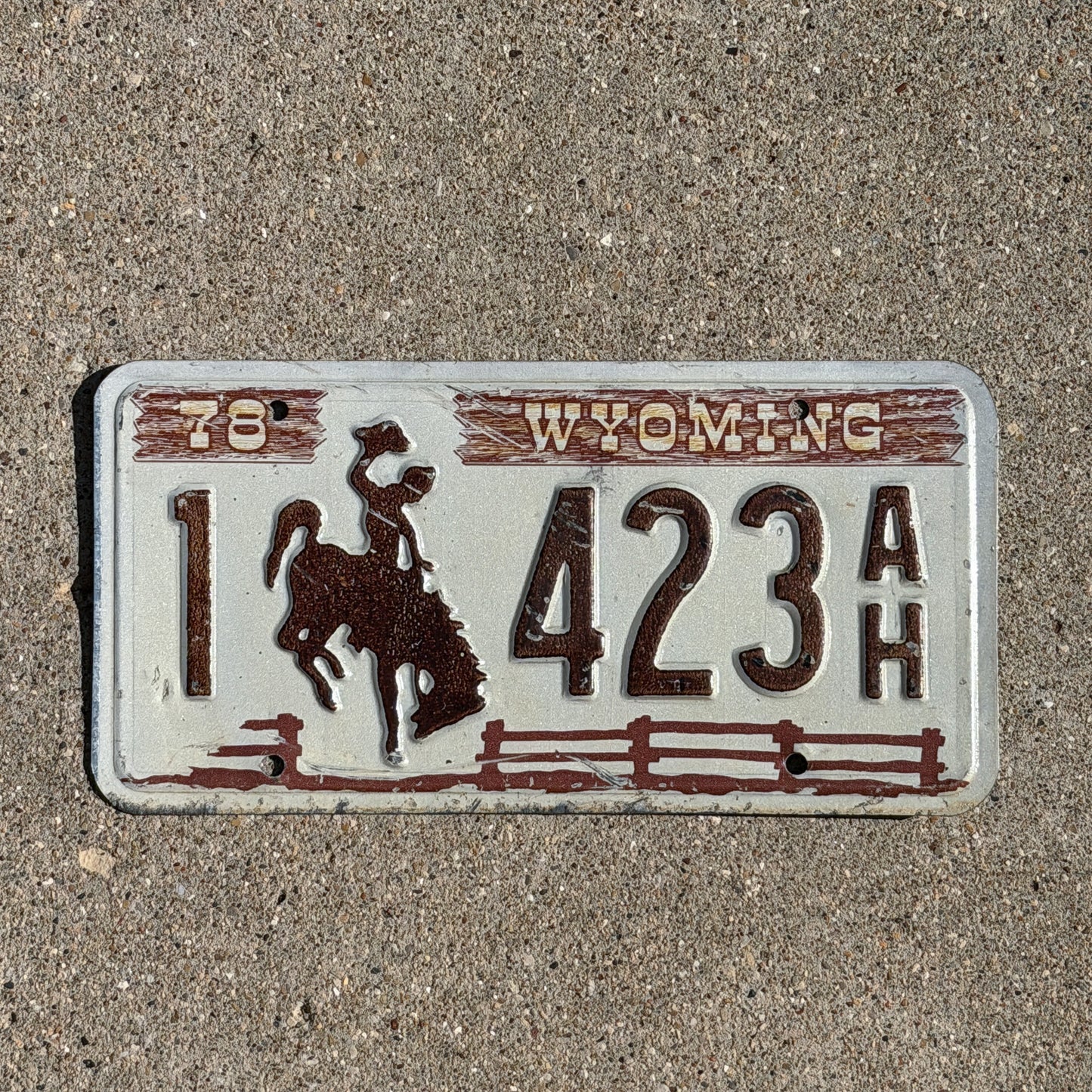 Photo of a 1978 Wyoming License Plate Auto Tag Garage Decor Vintage Cowboy Rodeo 1 423 AH with original patina