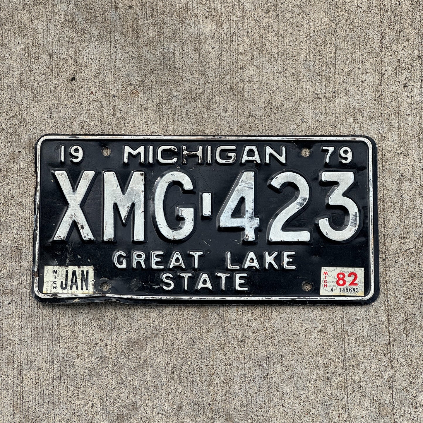 Photo of a 1979 1982 Michigan License Plate Auto Tag Garage Decor Vintage XMG 423 with original patina