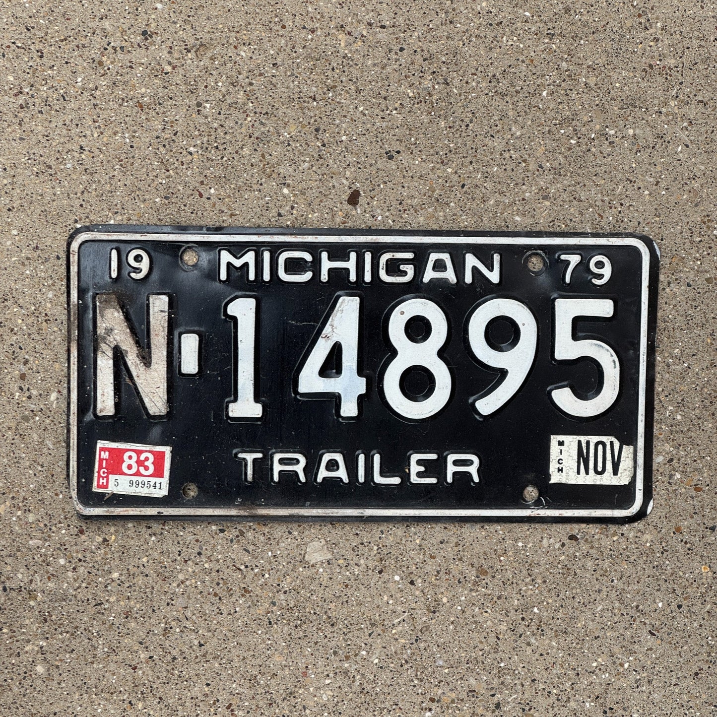 Photo of a 1979 1983 Michigan Trailer License Plate Auto Tag Garage Decor Vintage N 14895