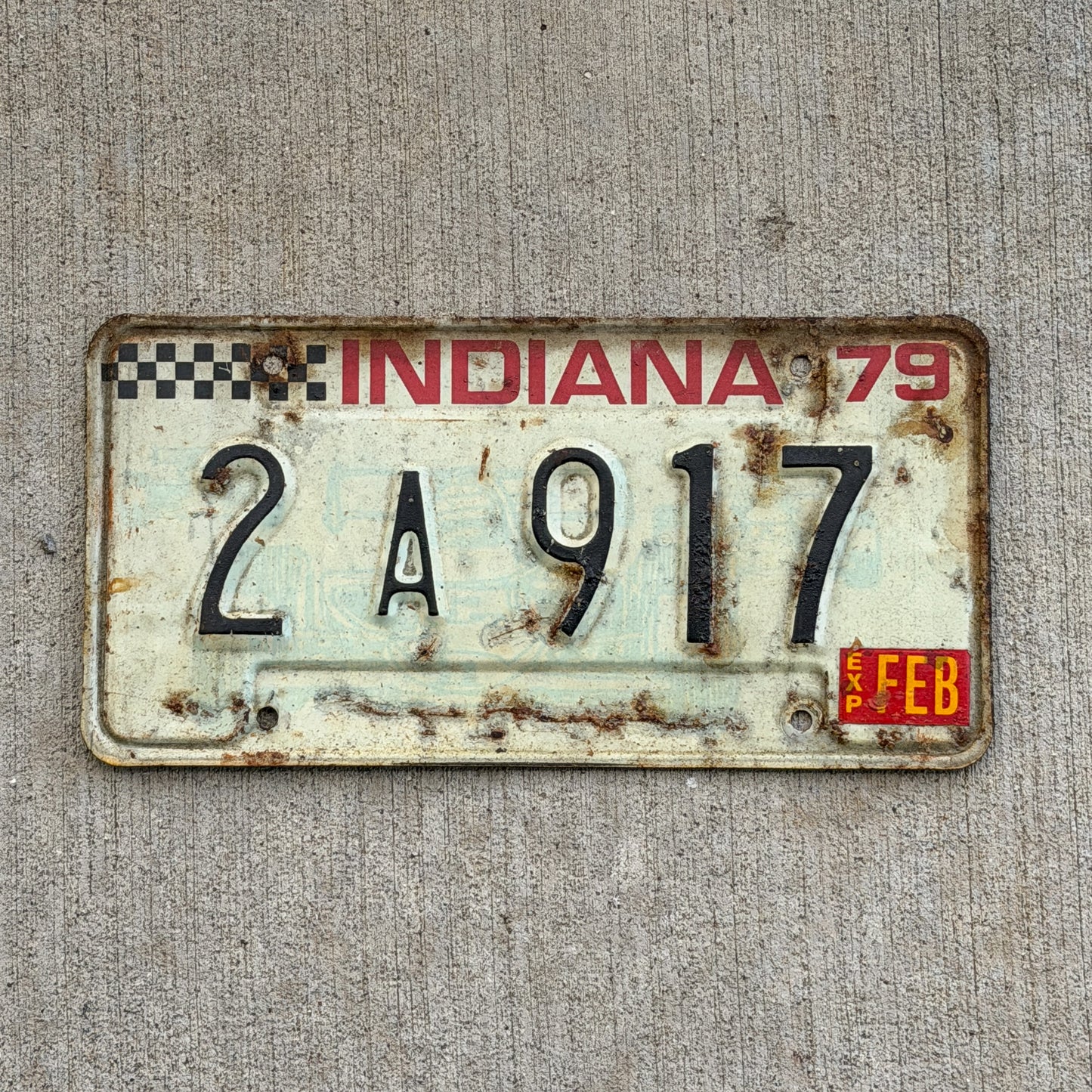 Photo of a 1979 Indiana License Plate Auto Tag Garage Decor Vintage Checkered Race Car 2 A 917 with original patina