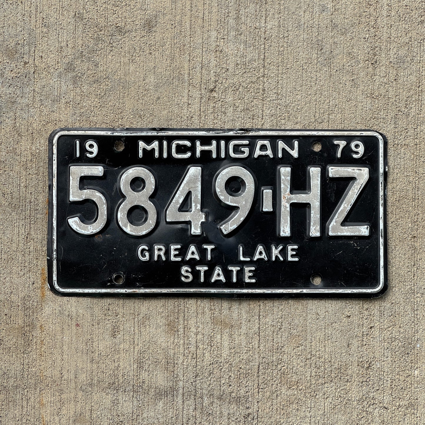 Photo of a 1979 Michigan Commercial License Plate Auto Tag Garage Decor Vintage 5849 HZ with original patina