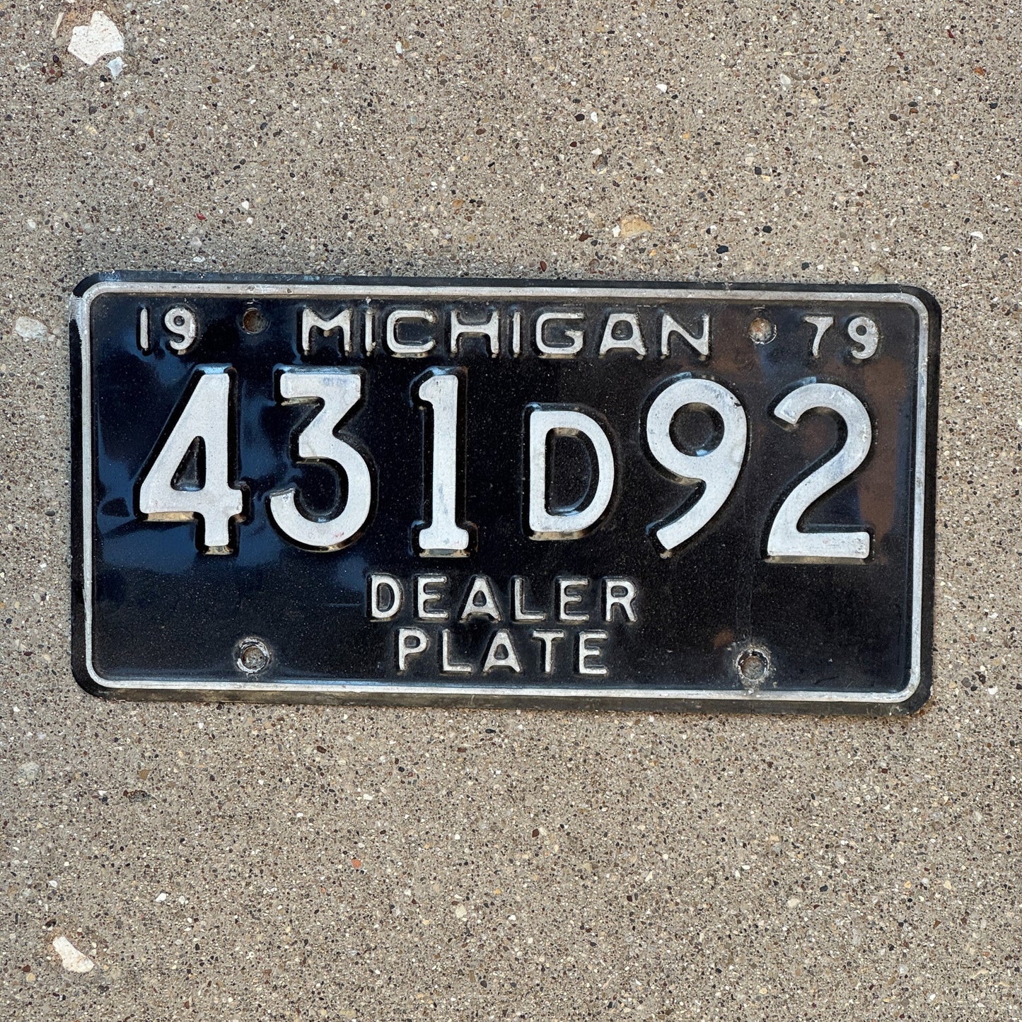 Photo of a 1979 Michigan Dealer License Plate Auto Tag Garage Decor Vintage 431 D 92
