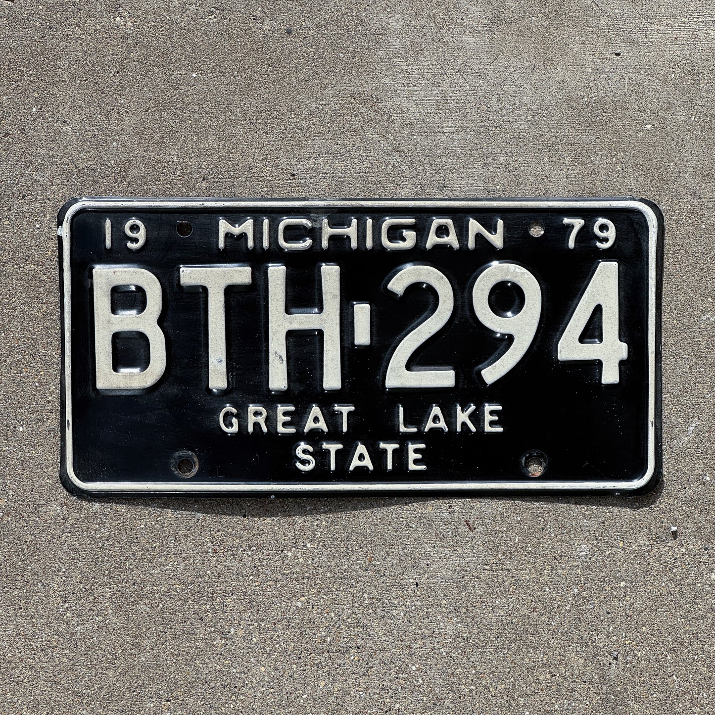 Photo of a 1979 Michigan License Plate Auto Tag 2 Vintage Garage BTH 294 with original patina