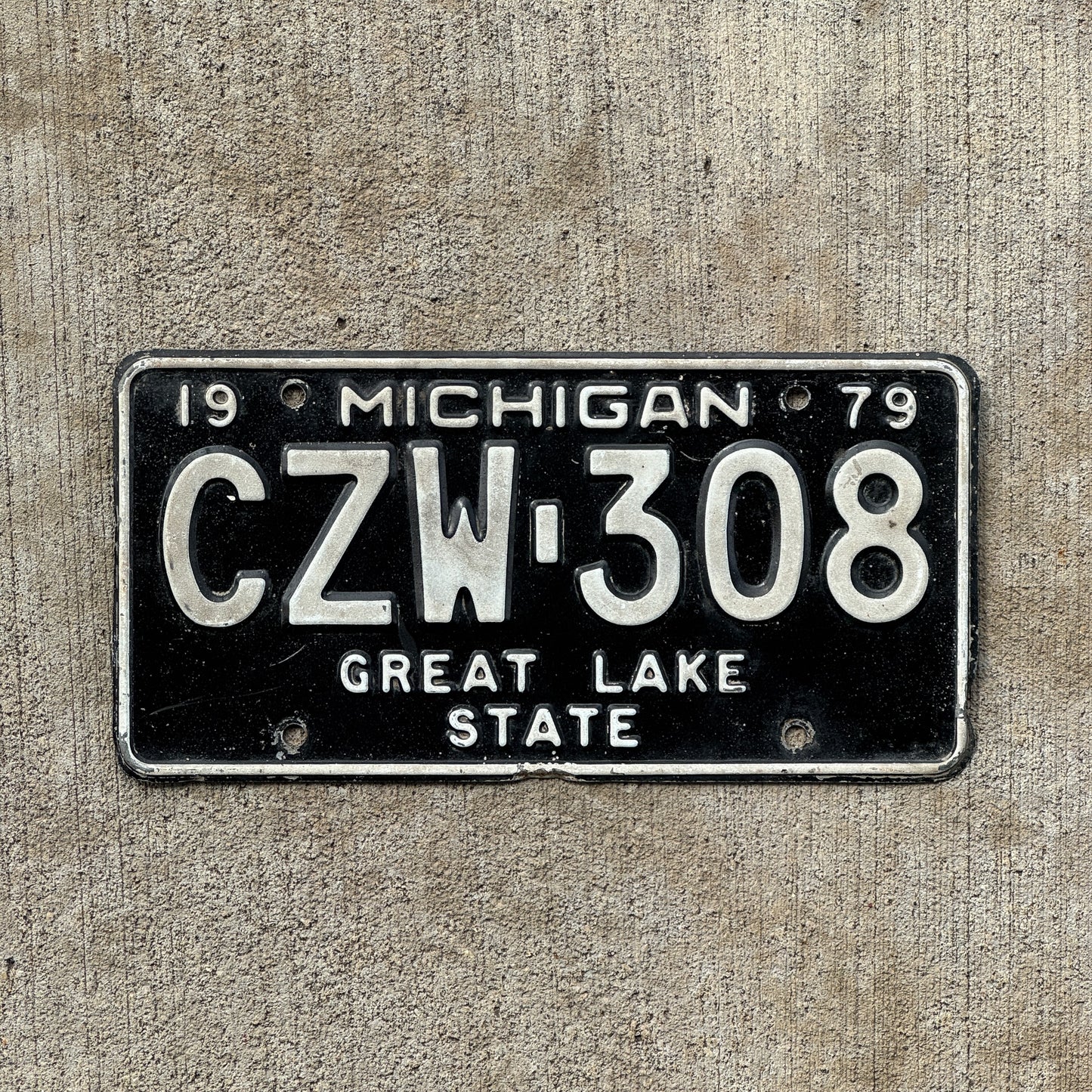 Photo of a 1979 Michigan License Plate Auto Tag Garage Decor Vintage CZW 308 with original patina