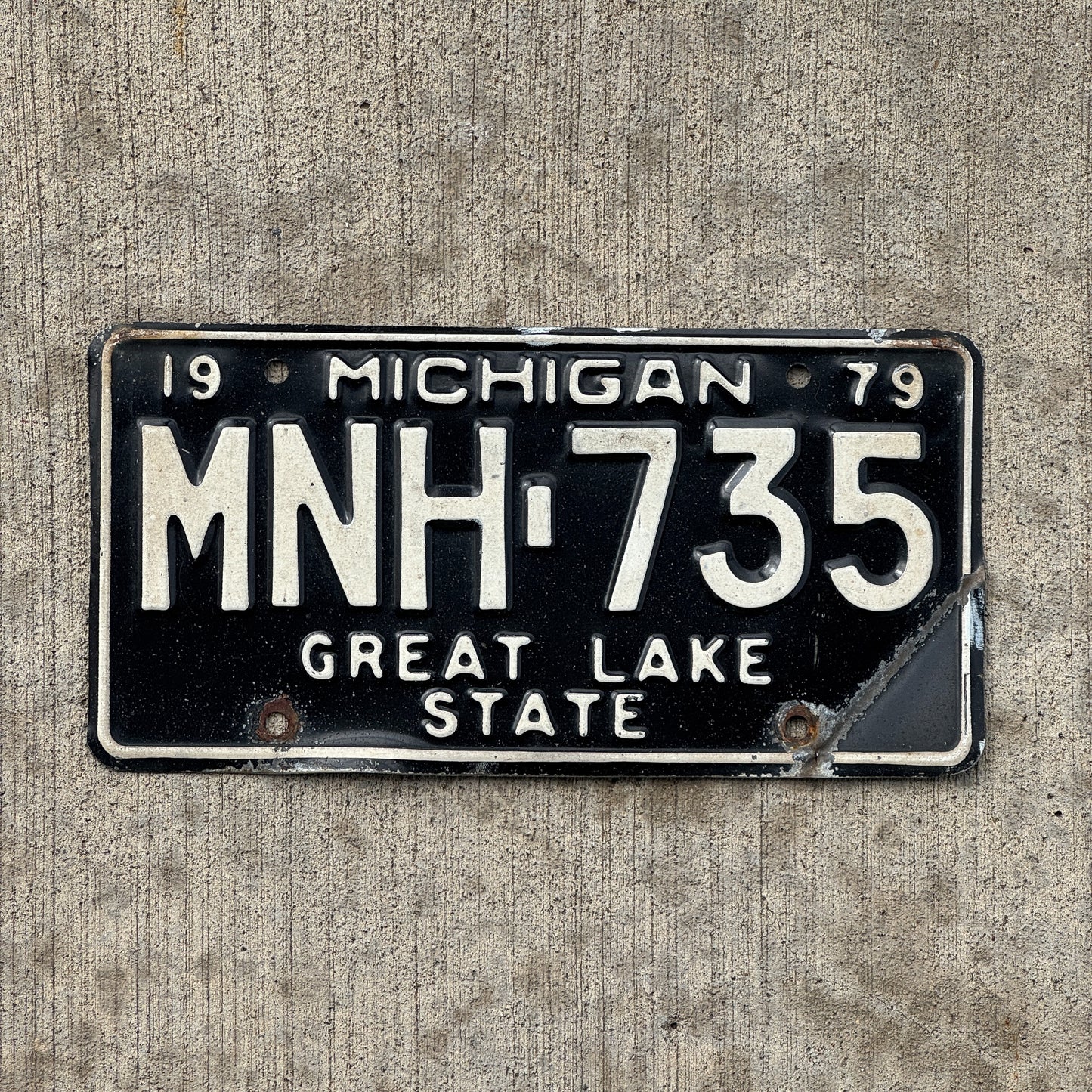 Photo of a 1979 Michigan License Plate Auto Tag Garage Decor Vintage MNH 735 with original patina