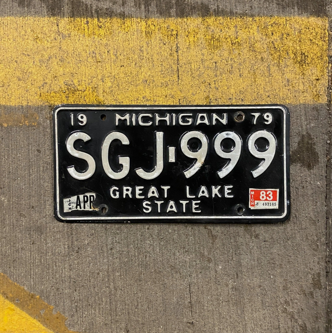 Photo of a 1979 Michigan License Plate Auto Tag Garage Decor Vintage Repeat Repeating Black SGJ 999
