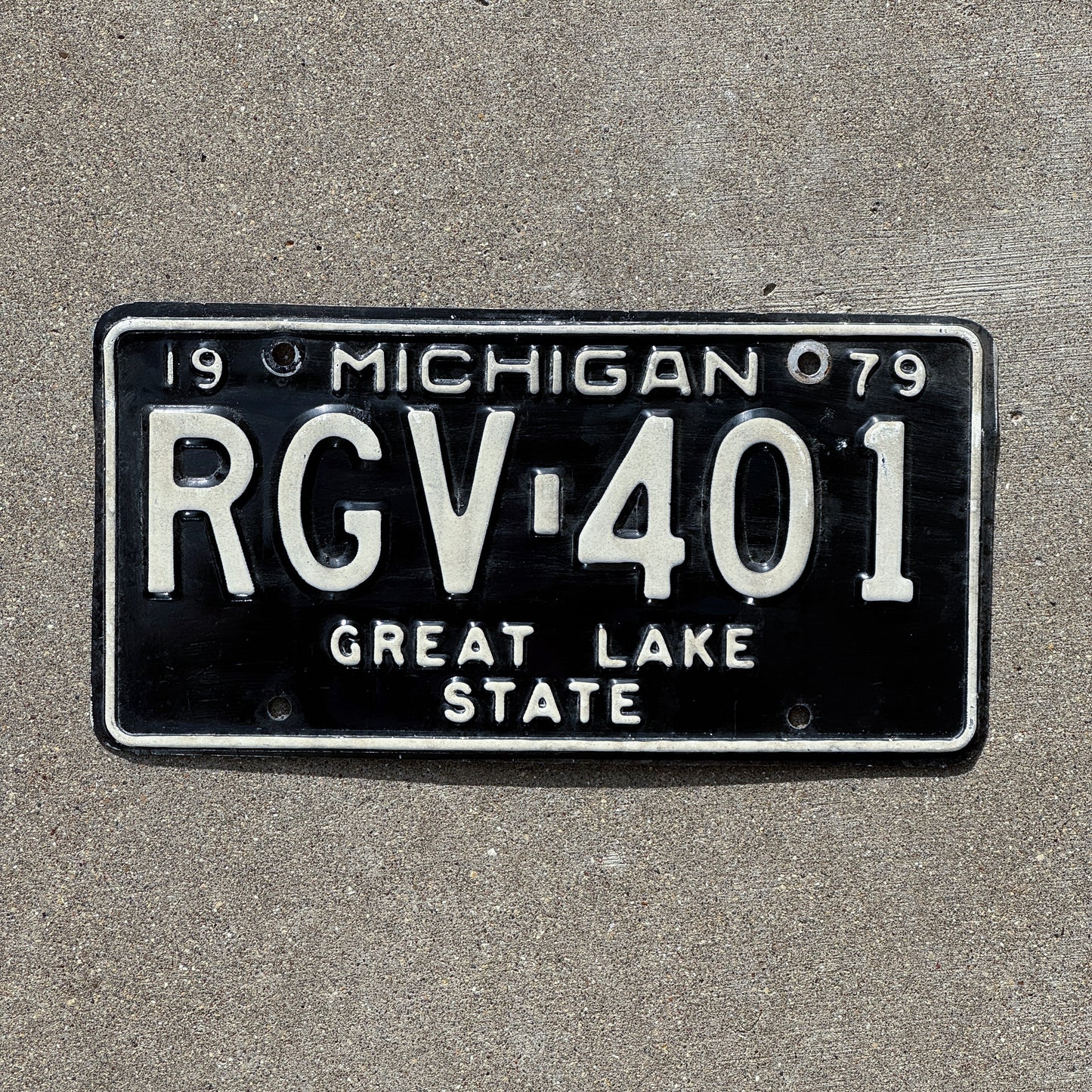 Photo of a 1979 Michigan License Plate Auto Tag Garage Decor Vintage RGV 401 with original patina