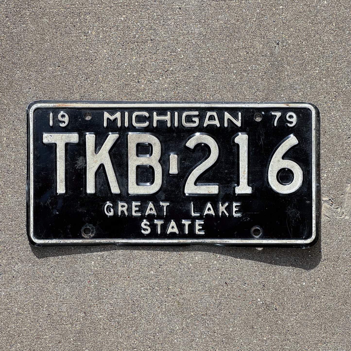 Photo of a 1979 Michigan License Plate Auto Tag Garage Decor Vintage TKB 216 with original patina