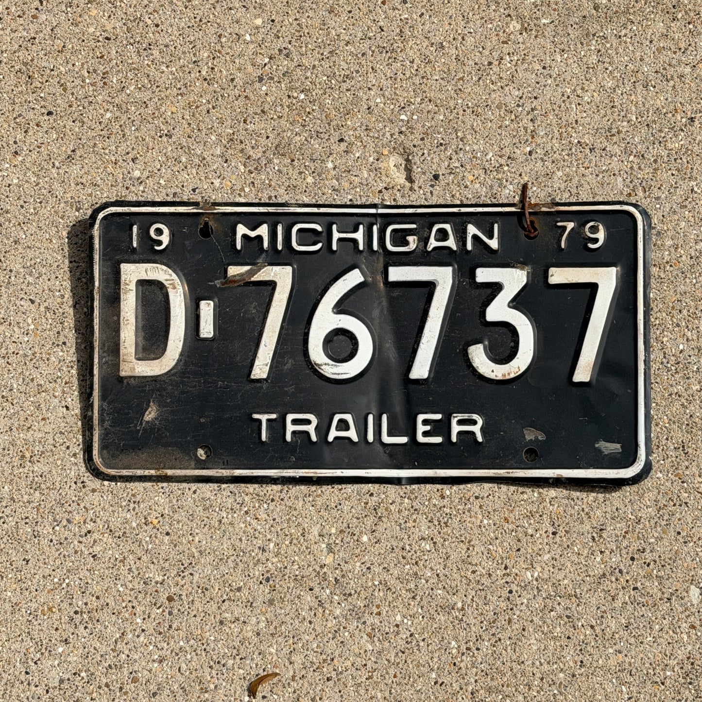 Photo of a 1979 Michigan Trailer License Plate Auto Tag Garage Decor Vintage D 76737 with original patina