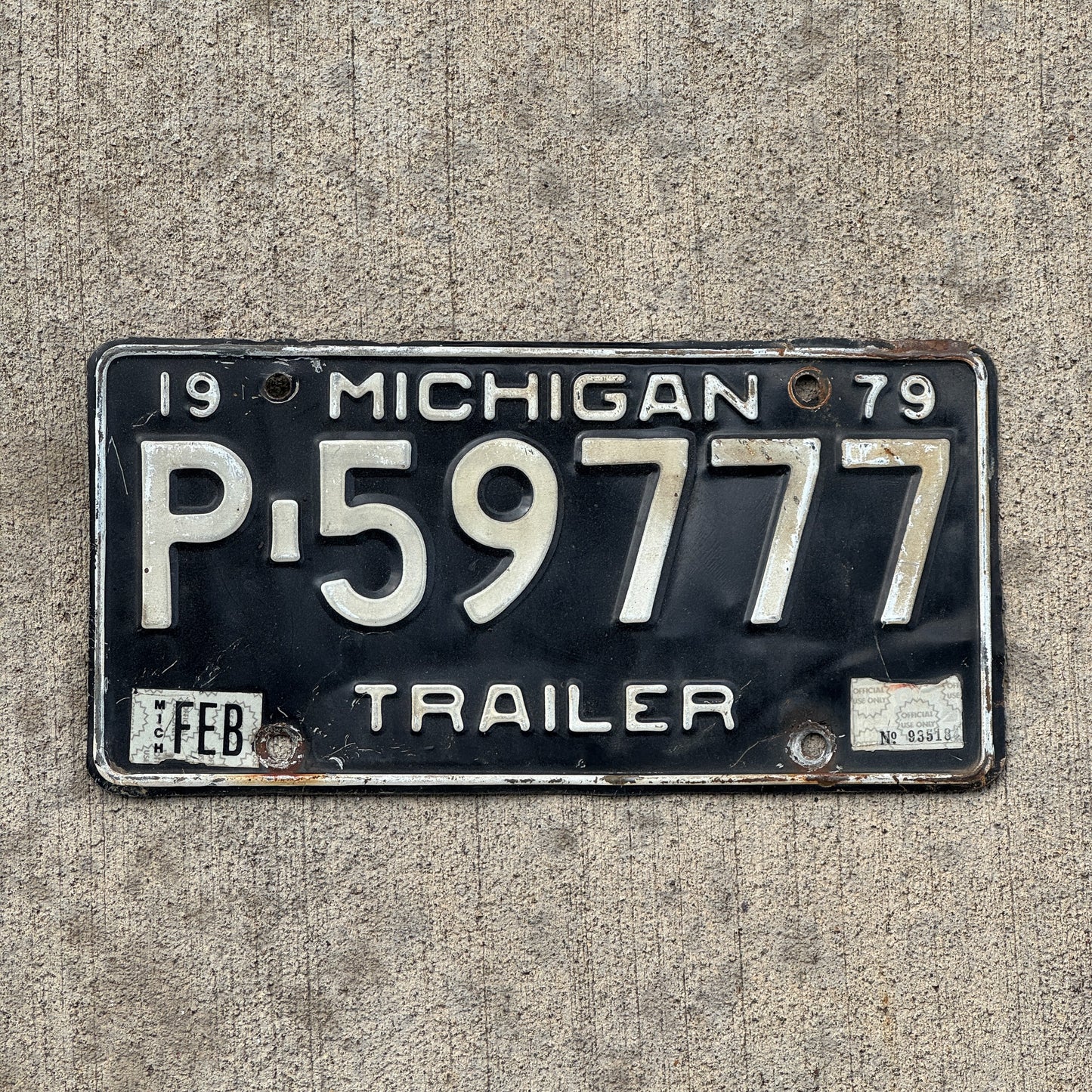 Photo of a 1979 Michigan Trailer License Plate Auto Tag Garage Decor Vintage Lucky 7 Repeat Repeating P 59777 with original patina