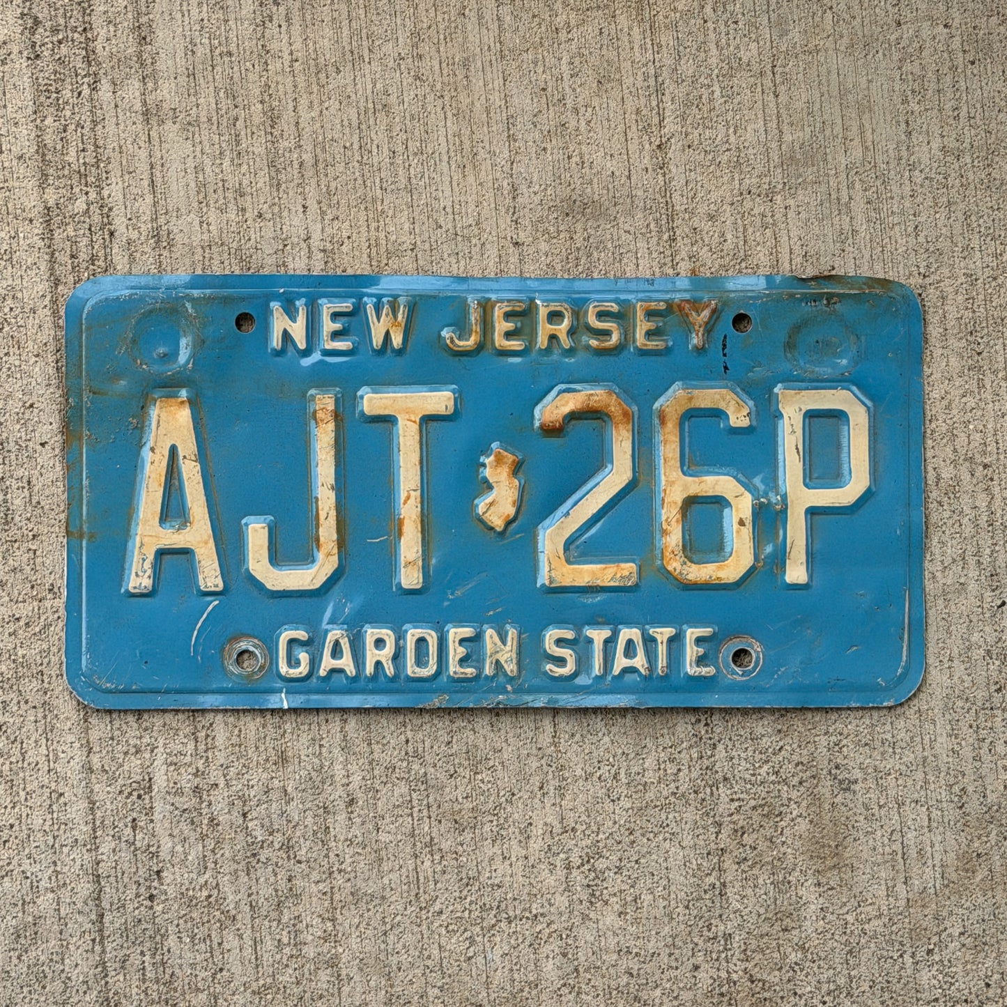 Photo of a 1979 New Jersey License Plate Auto Tag Garage Decor Vintage Blue AJT 26P with original patina