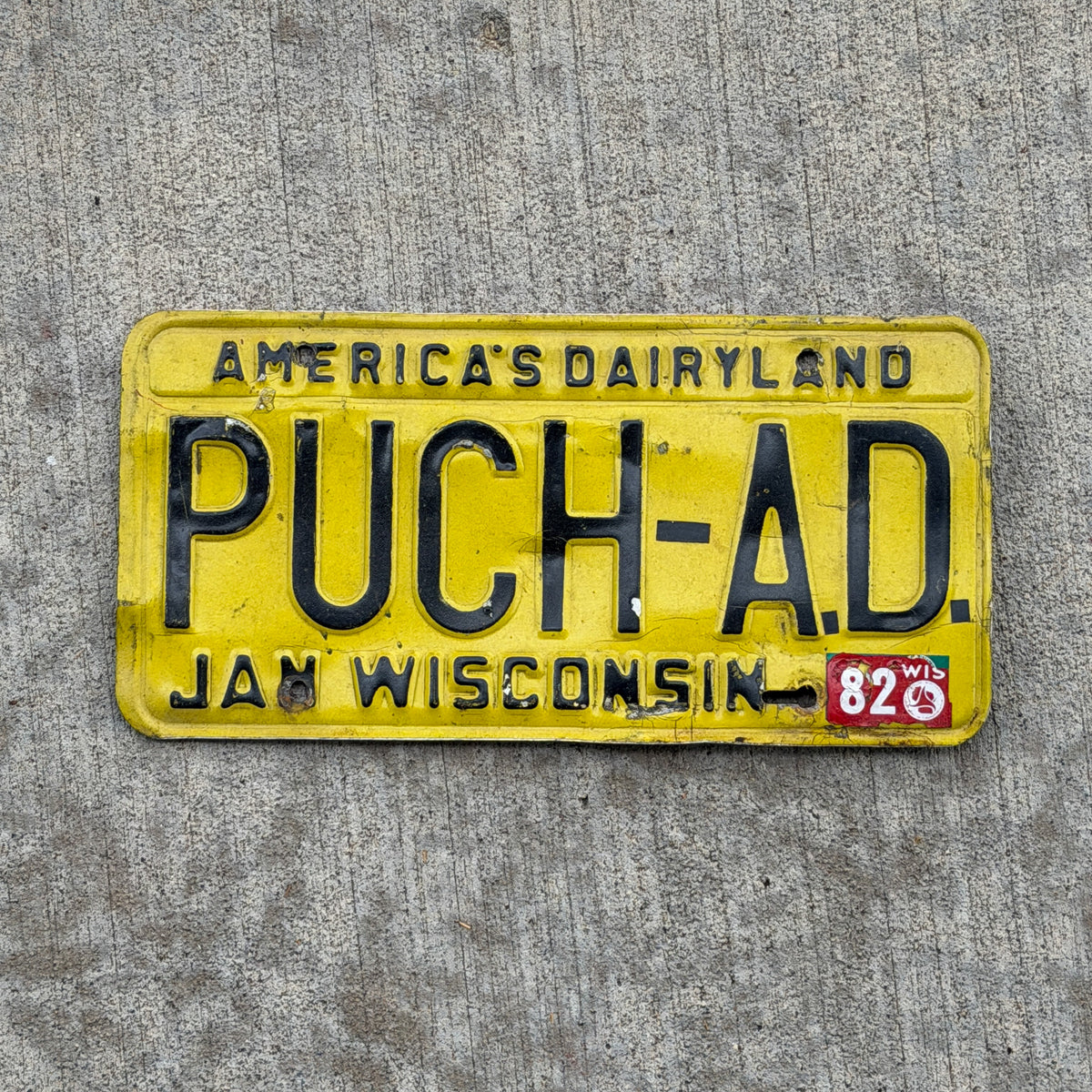 Photo of a 1980 1982 Wisconsin Vanity License Plate Auto Tag 1 Vintage Garage PUCH AD with original patina
