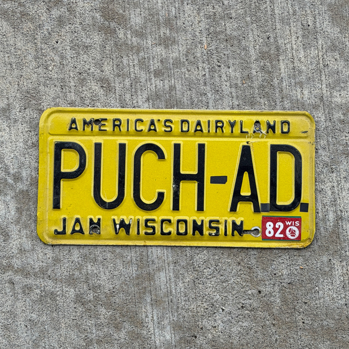 Photo of a 1980 1982 Wisconsin Vanity License Plate Auto Tag 2 Vintage Garage PUCH AD with original patina