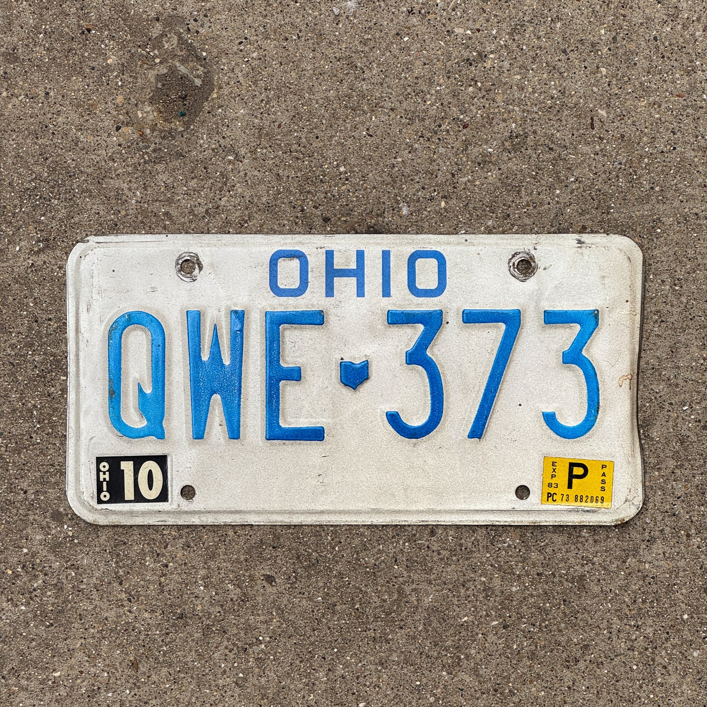 Photo of a 1980 1983 Ohio License Plate Auto Tag 1 Vintage Garage QWE 373 with original patina