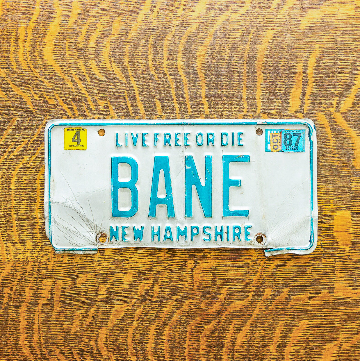 Photo of a 1980 1987 New Hampshire License Plate Auto Tag Garage Decor Vintage Super Villain Batman Comic BANE with original patina