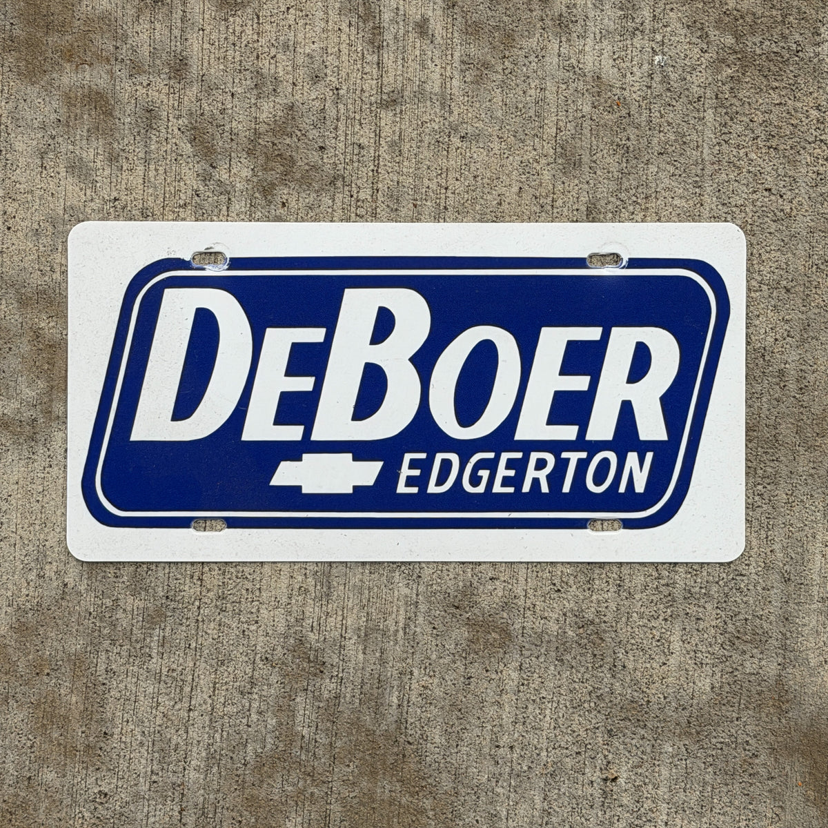 Photo of a 1980 Era Edgerton Minnesota Booster License Plate Auto Tag Garage Decor Vintage DeBoer Chevy Plastic with original patina