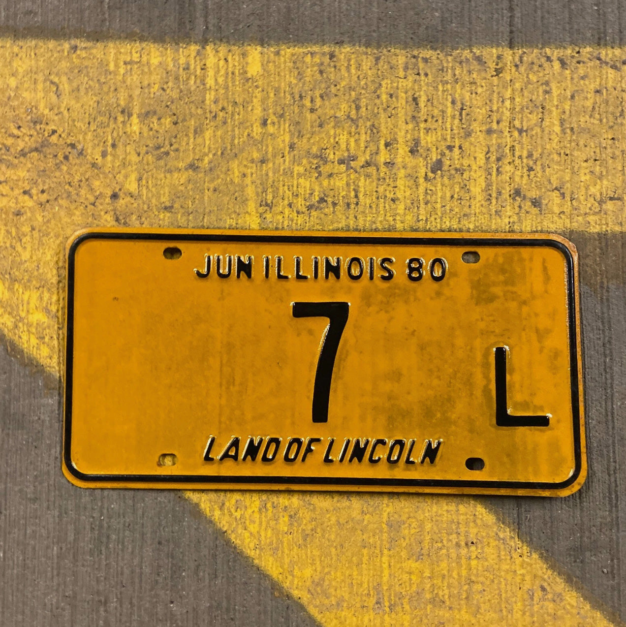 Photo of a 1980 Illinois Truck License Plate Auto Tag Garage Decor Vintage Low Number Single Digit 7 L with original patina