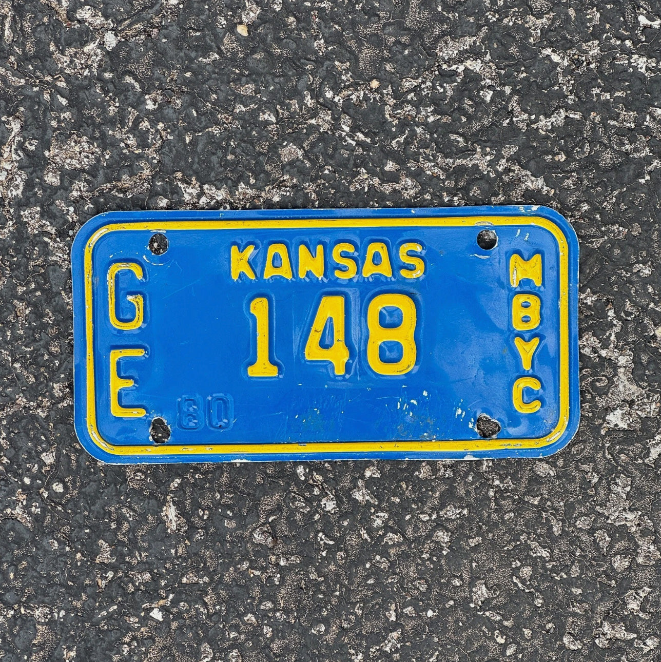 Photo of a 1980 Kansas Moped License Plate Auto Tag Garage Decor Vintage GE 148