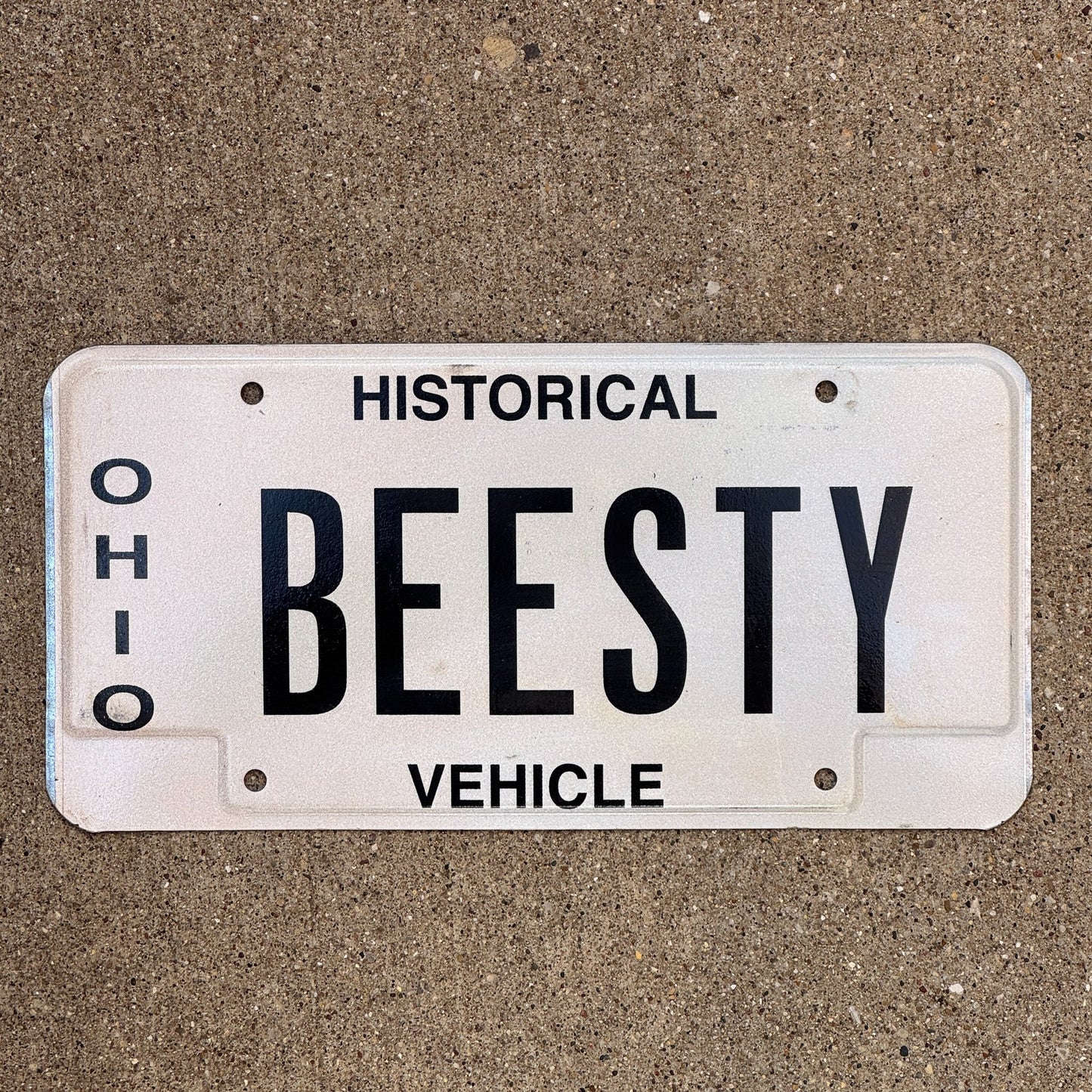 Photo of a 1980 Ohio Historical Vehicle Vanity License Plate Auto Tag Garage Decor Vintage Bees Besty BEESTY with original patina