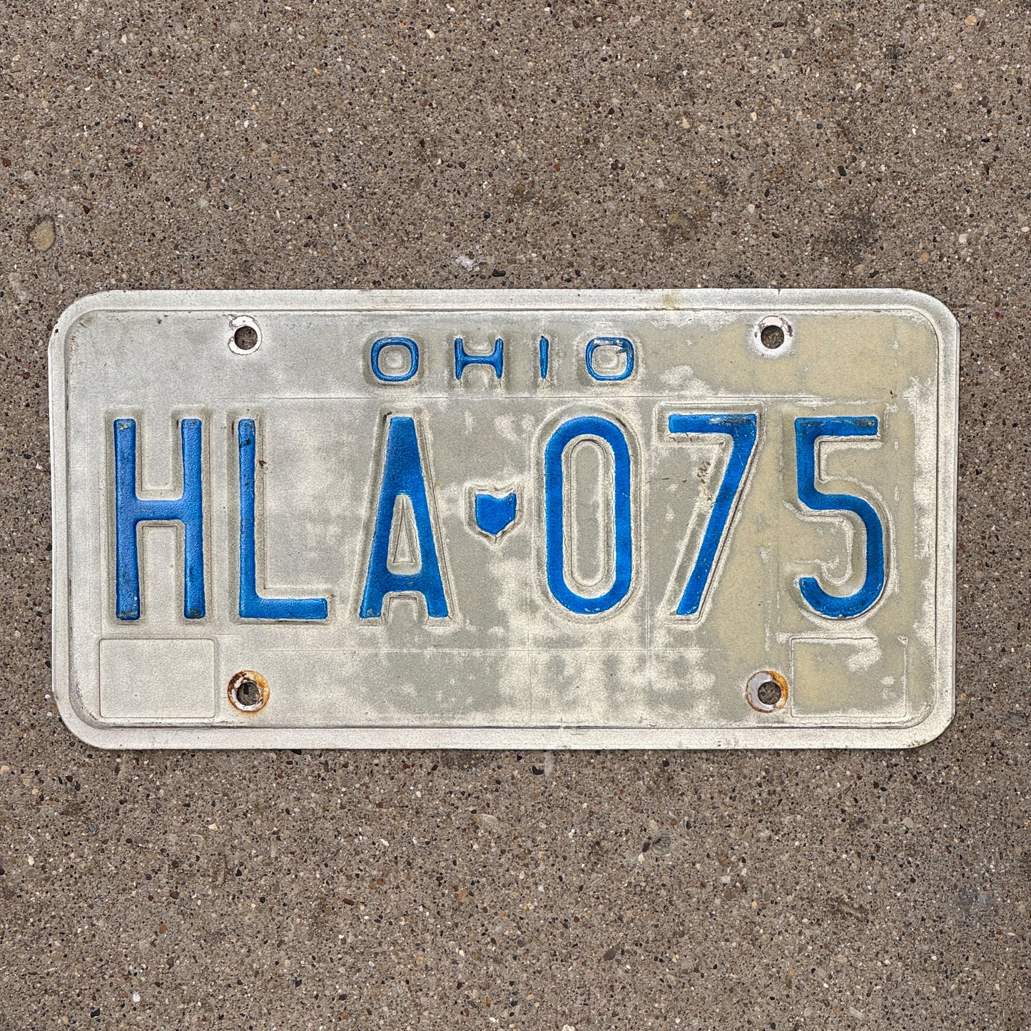 Photo of a 1980 Ohio License Plate Auto Tag 2 Vintage Garage HLA 075 with original patina
