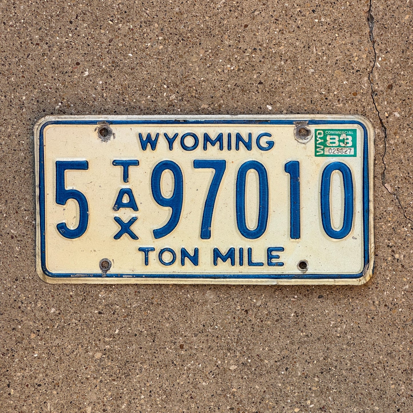 Photo of a 1981 1983 Wyoming Ton Mile Tax License Plate Auto Tag Garage Decor Vintage 5 97010