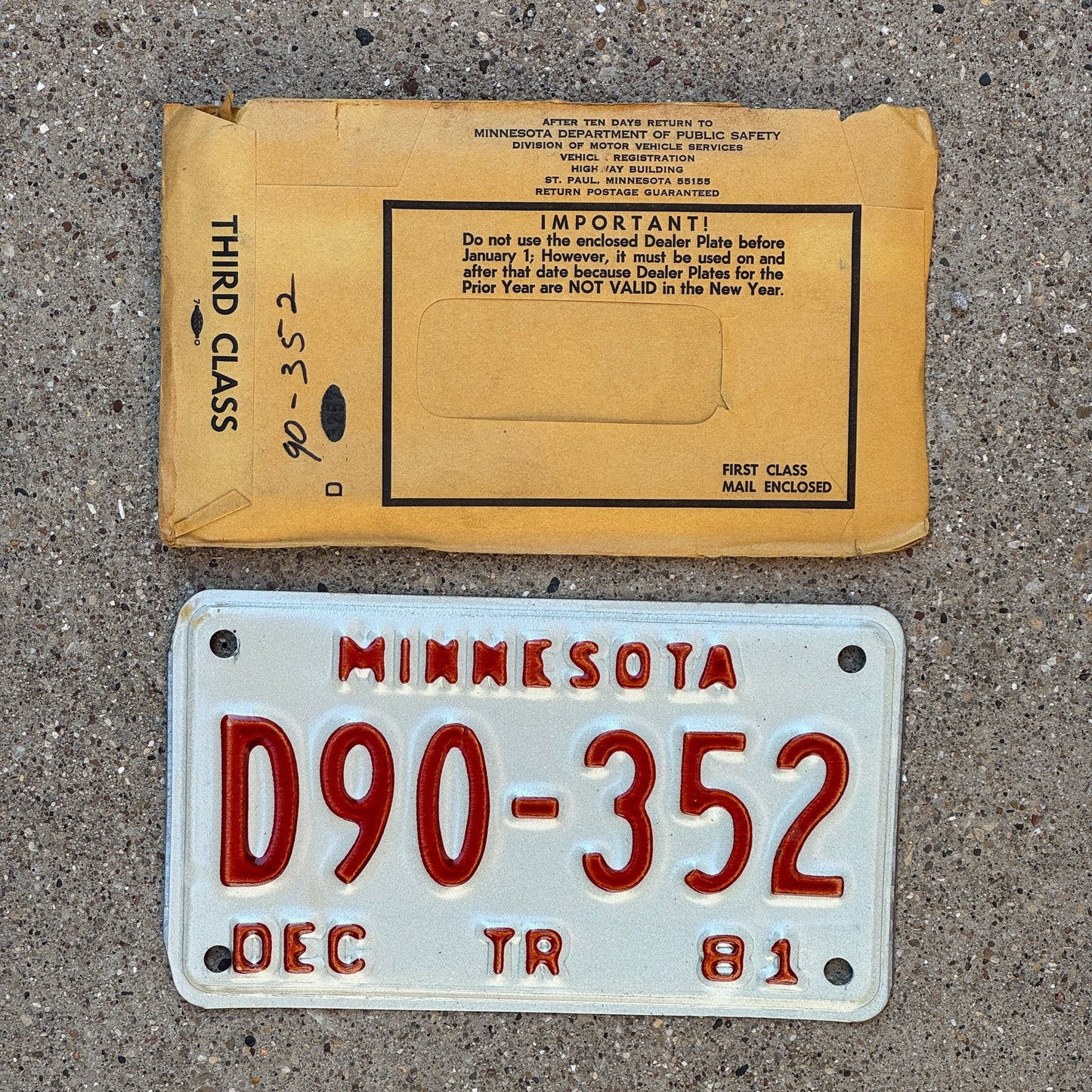 Photo of a 1981 Minnesota Trailer Dealer License Plate Auto Tag Garage Decor Vintage with Envelope D90 352