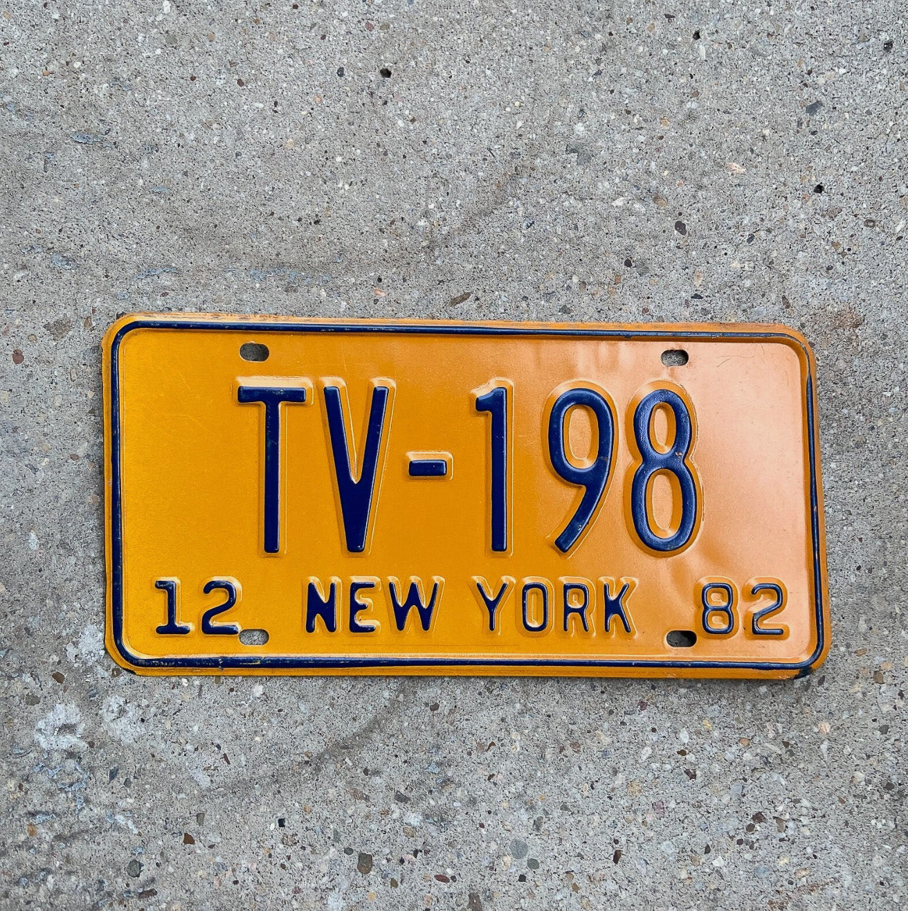 Photo of a 1982 New York Television License Plate Auto Tag Garage Decor Vintage TV 198 with original patina