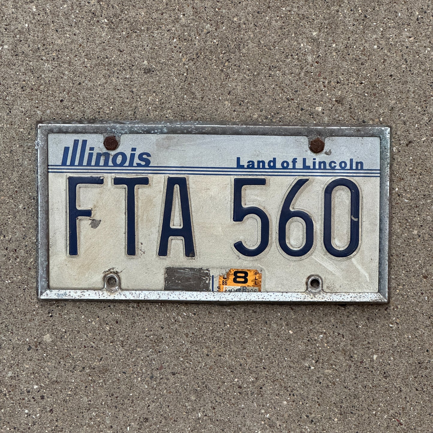 Photo of a 1983 1986 Illinois License Plate Auto Tag Garage Decor Vintage FTA 560 with original patina