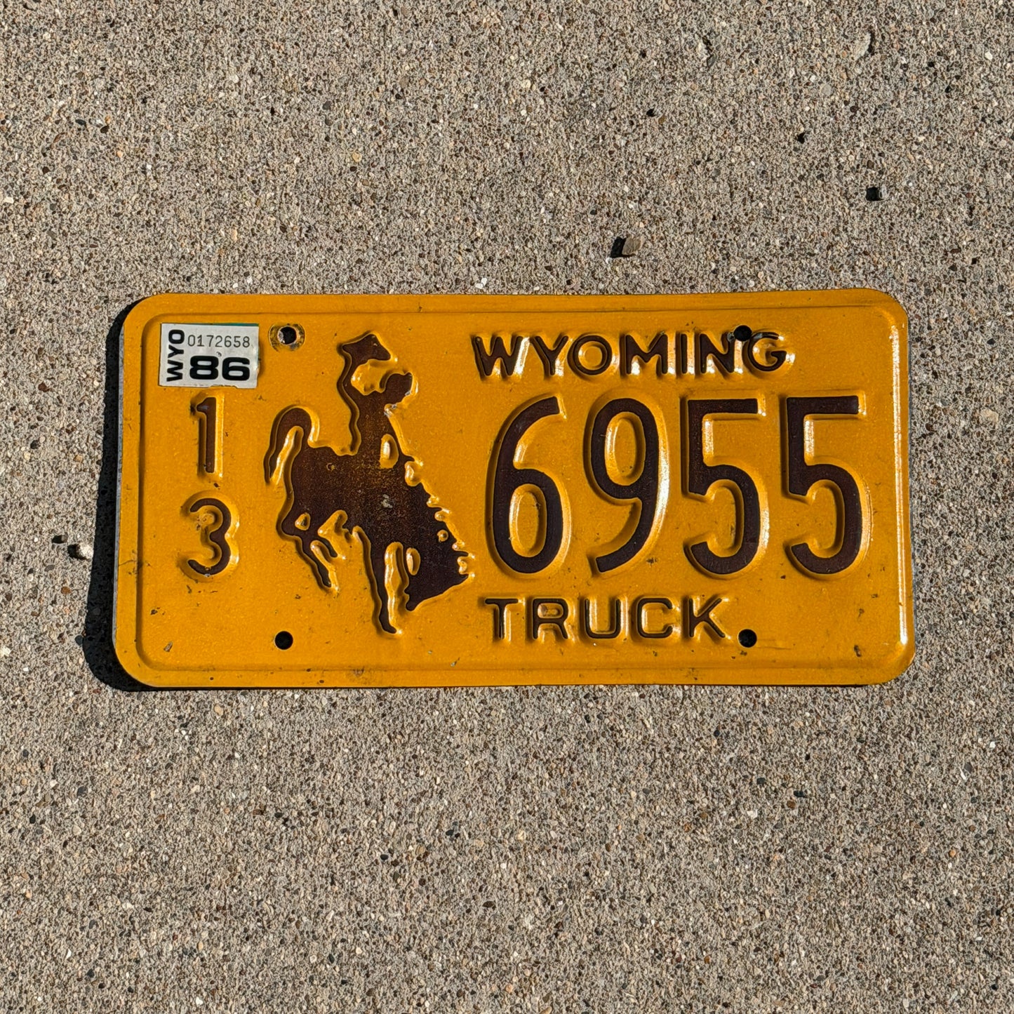 Photo of a 1983 1986 Wyoming Truck License Plate Auto Tag Garage Decor Vintage Cowboy Rodeo 13 6955 with original patina