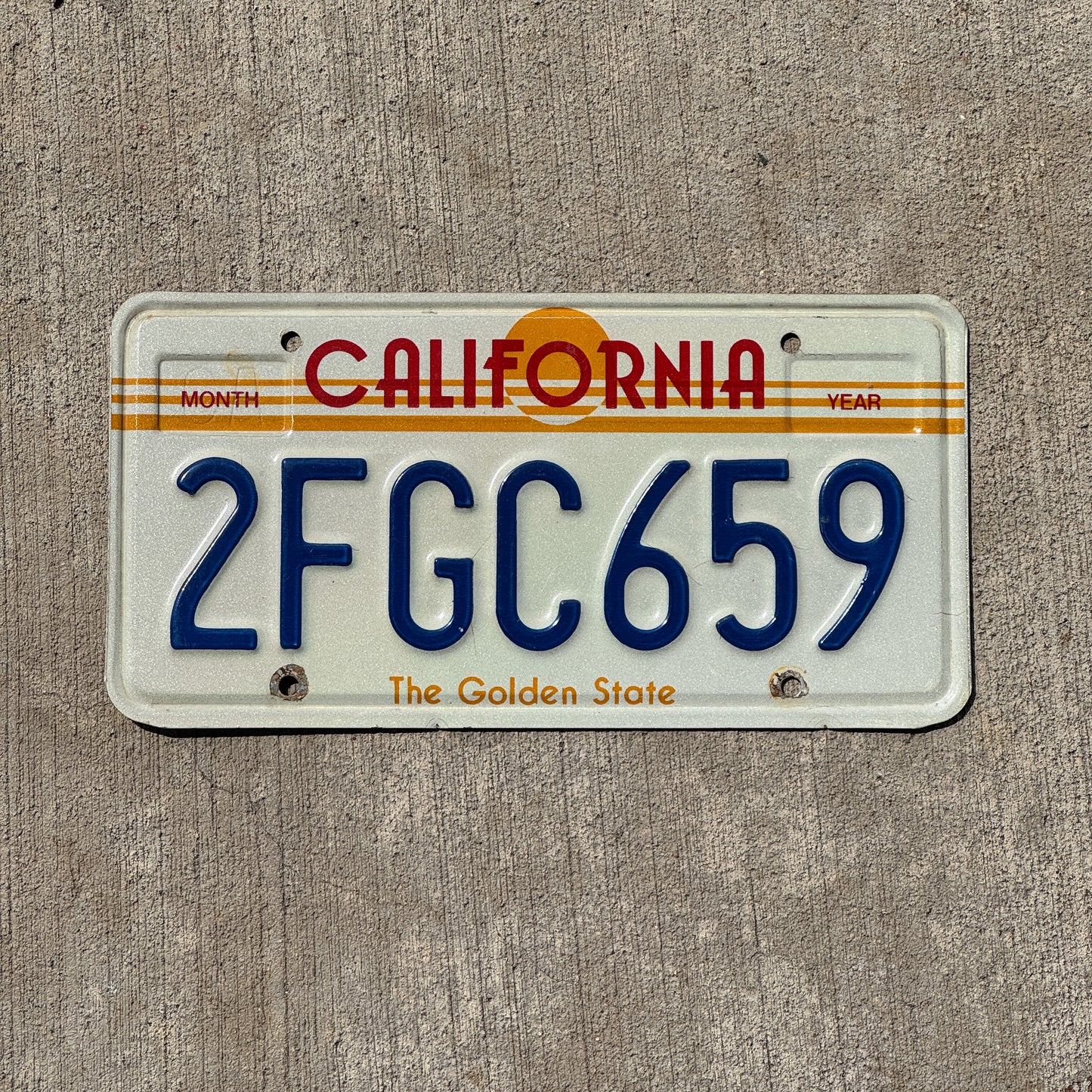 Photo of a 1983 California License Plate Auto Tag Garage Decor Vintage Golden State Sun Base 2 FGC 659 with original patina