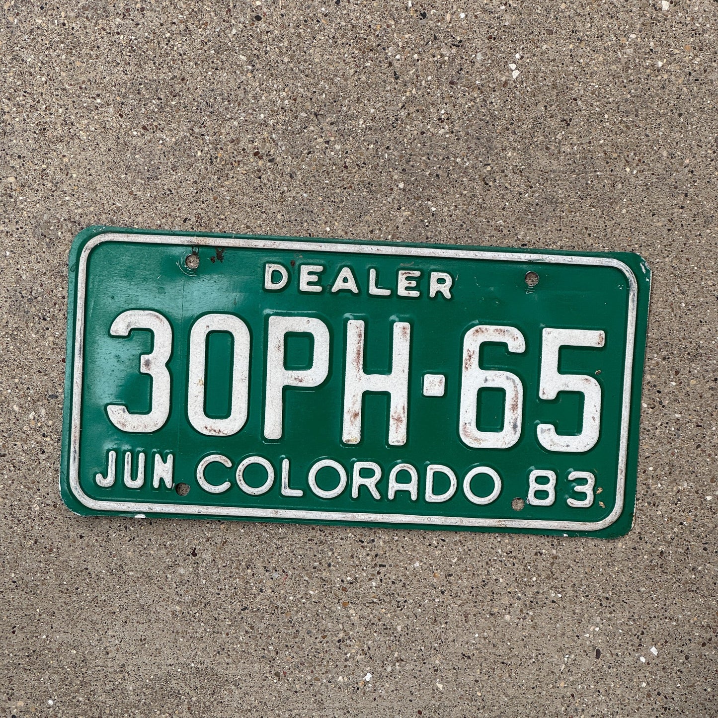Photo of a 1983 Colorado Dealer License Plate Auto Tag Garage Decor Vintage 30 PH 65