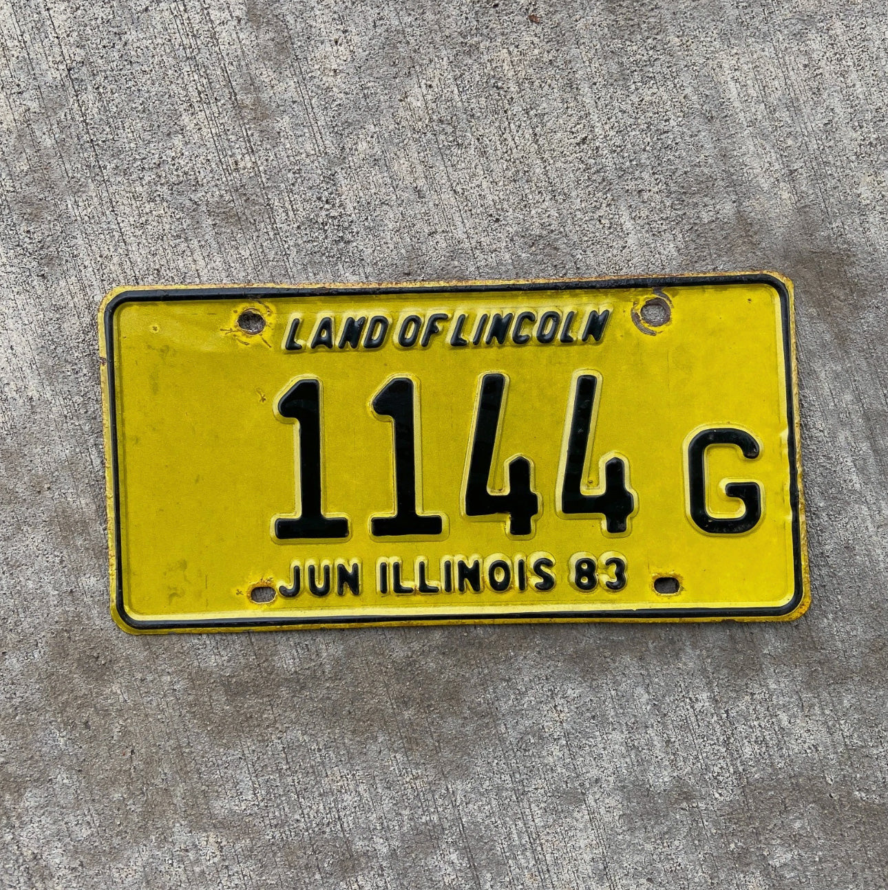 Photo of a 1983 Illinois Truck License Plate Auto Tag Garage Decor Vintage 1144 G with original patina