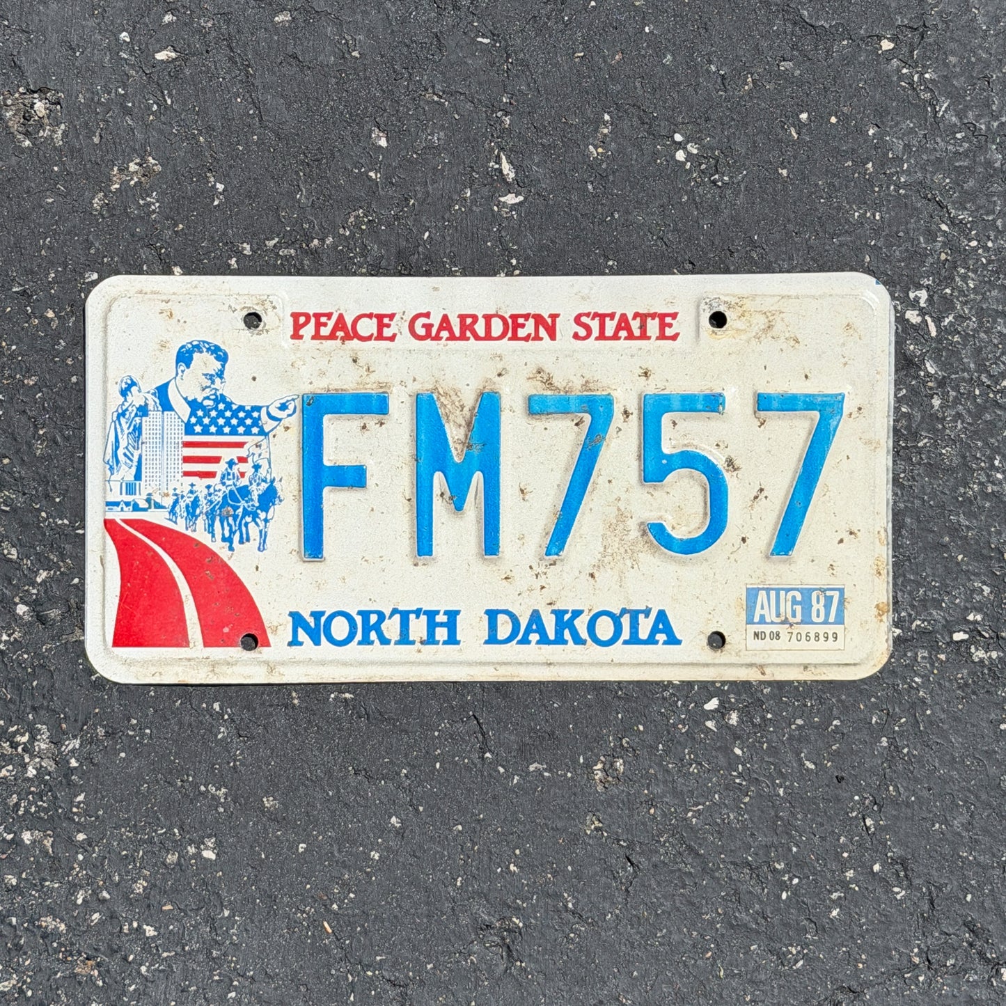Photo of a 1984 1987 North Dakota License Plate Auto Tag Garage Decor Vintage FM 757 with original patina