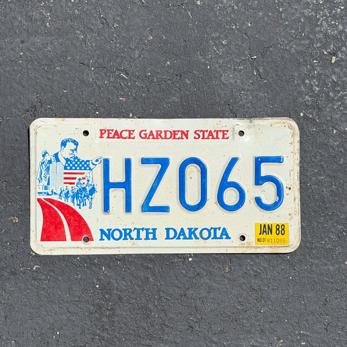 Photo of a 1984 1988 North Dakota License Plate Auto Tag Garage Decor Vintage HZ 065 with original patina