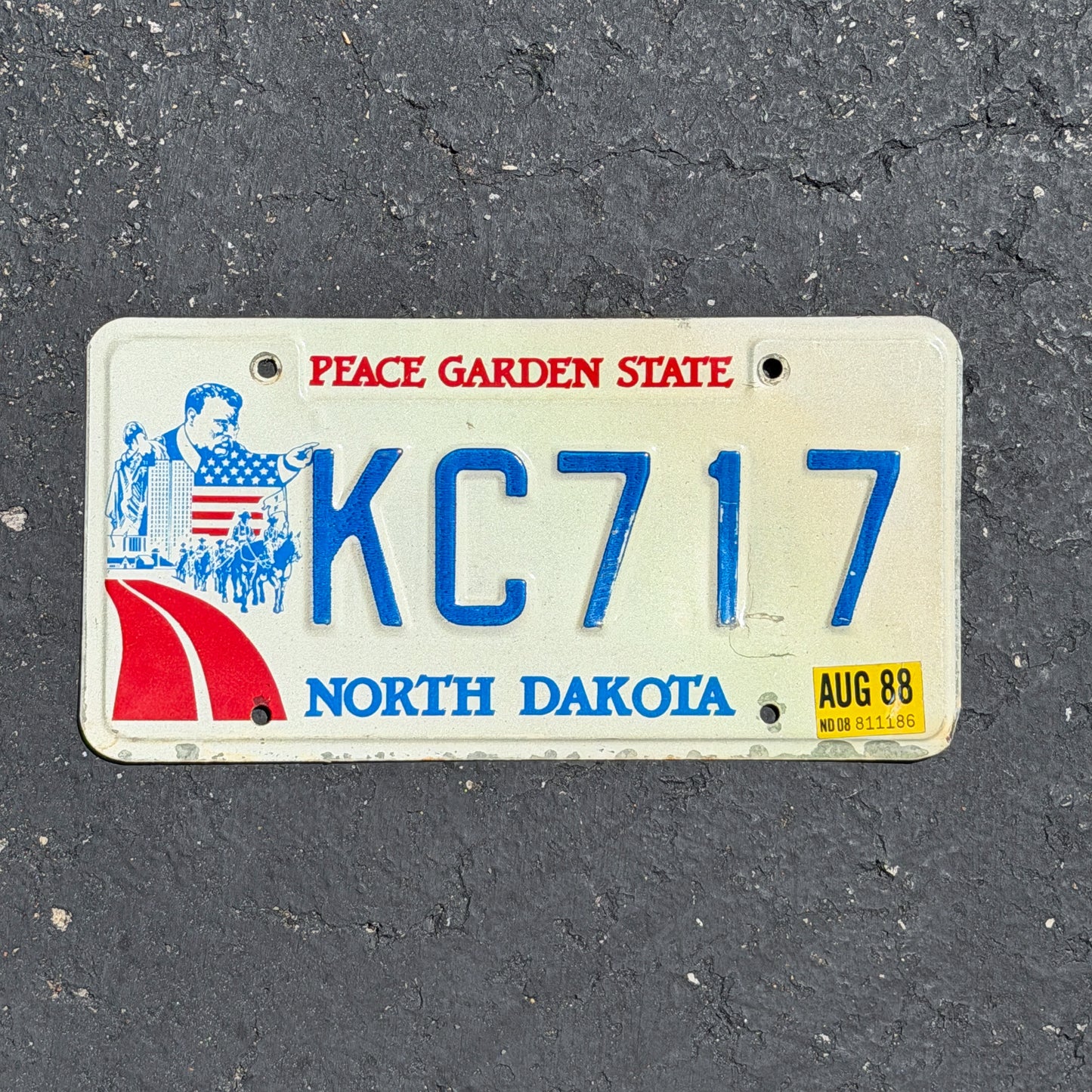 Photo of a 1984 1988 North Dakota License Plate Auto Tag Garage Decor Vintage KC 717 with original patina