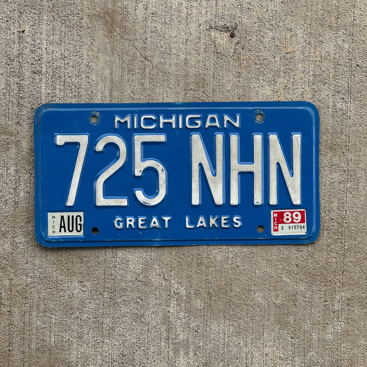 Photo of a 1984 1989 Michigan License Plate Auto Tag Garage Decor Vintage 725 NHN with original patina
