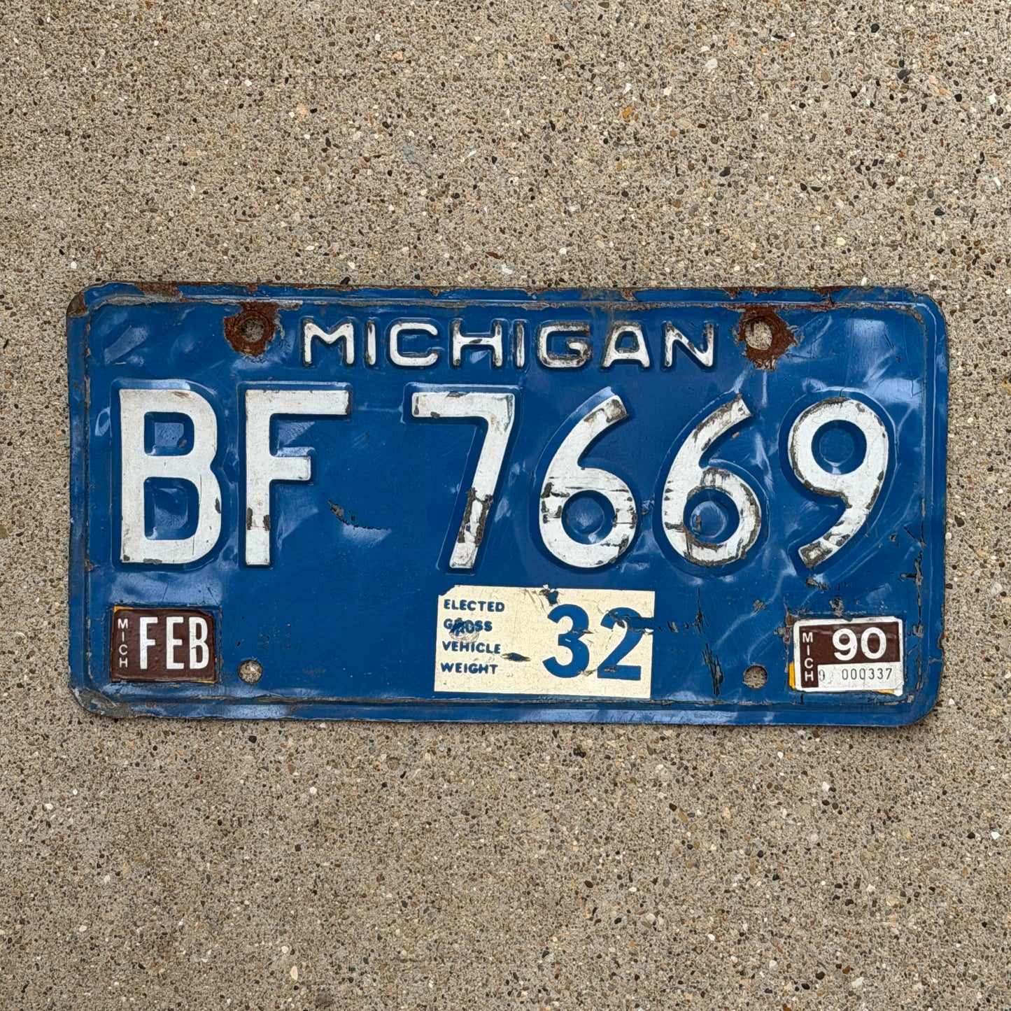 Photo of a 1984 1990 Michigan Commercial License Plate Auto Tag Garage Decor Vintage Heavy Commercial BF 7669 with original patina