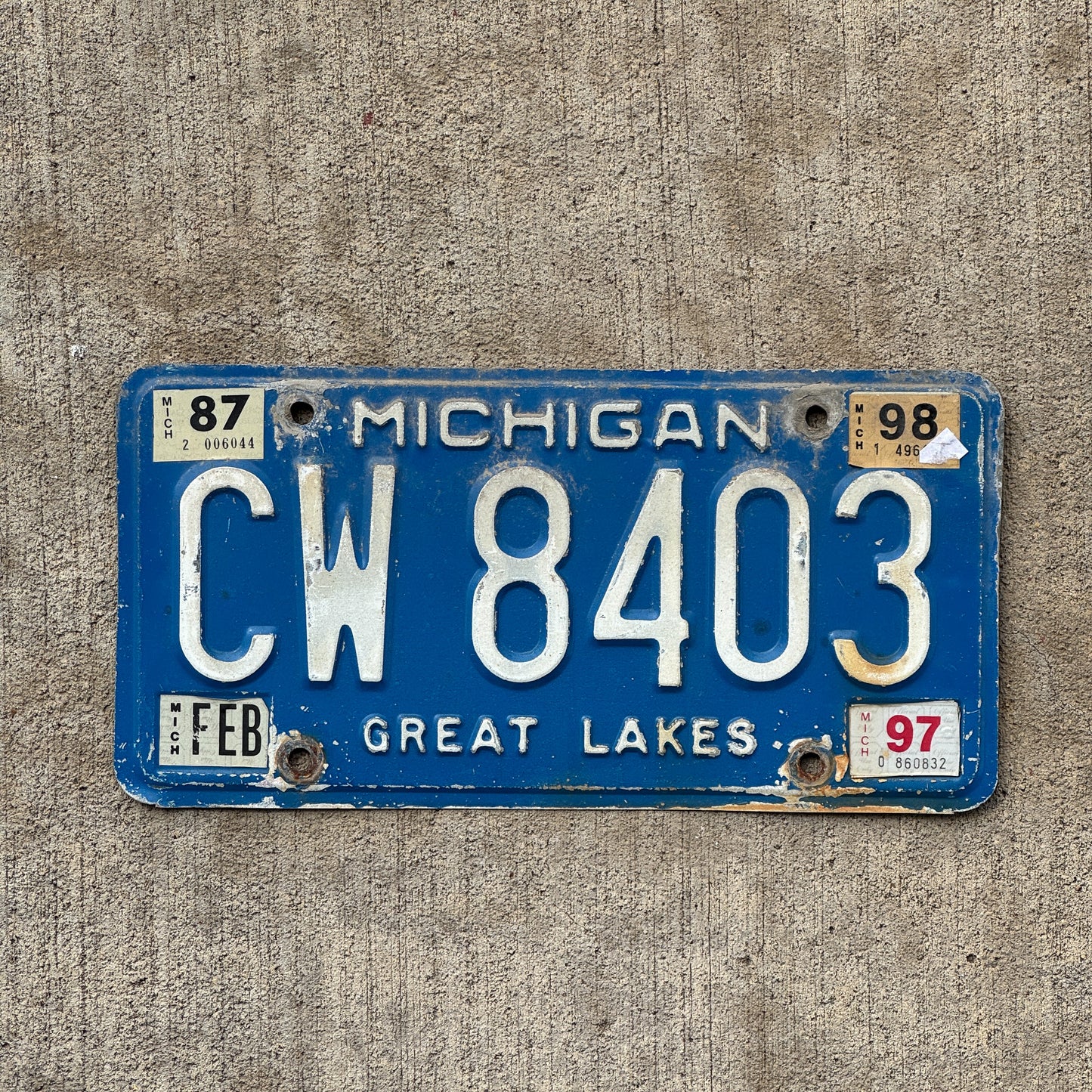 Photo of a 1984 1998 Michigan Commercial License Plate Auto Tag Garage Decor Vintage CW 8403 with original patina